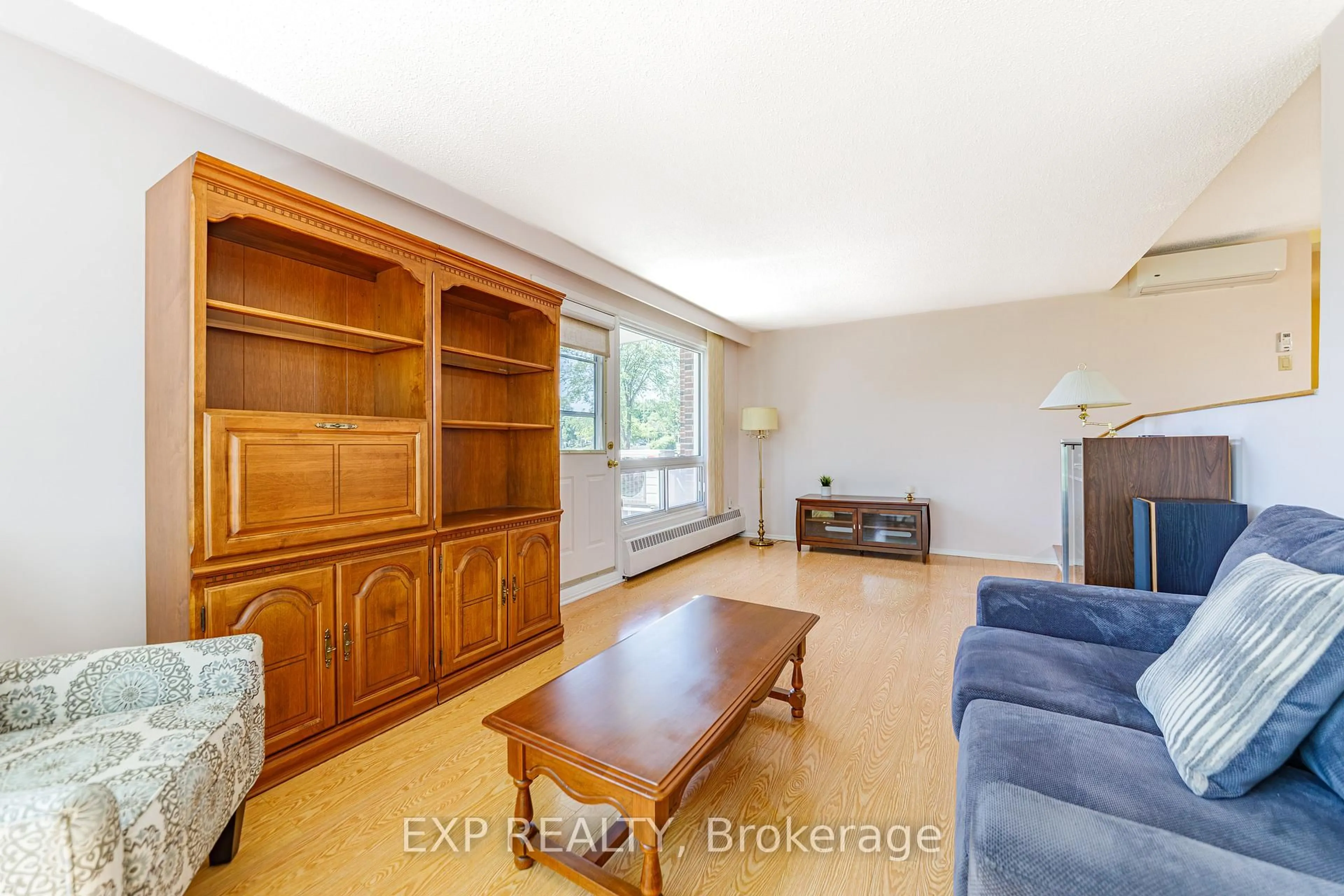 Living room with furniture, wood/laminate floor for 915 Elmsmere Rd #203, Ottawa Ontario K1J 8H8