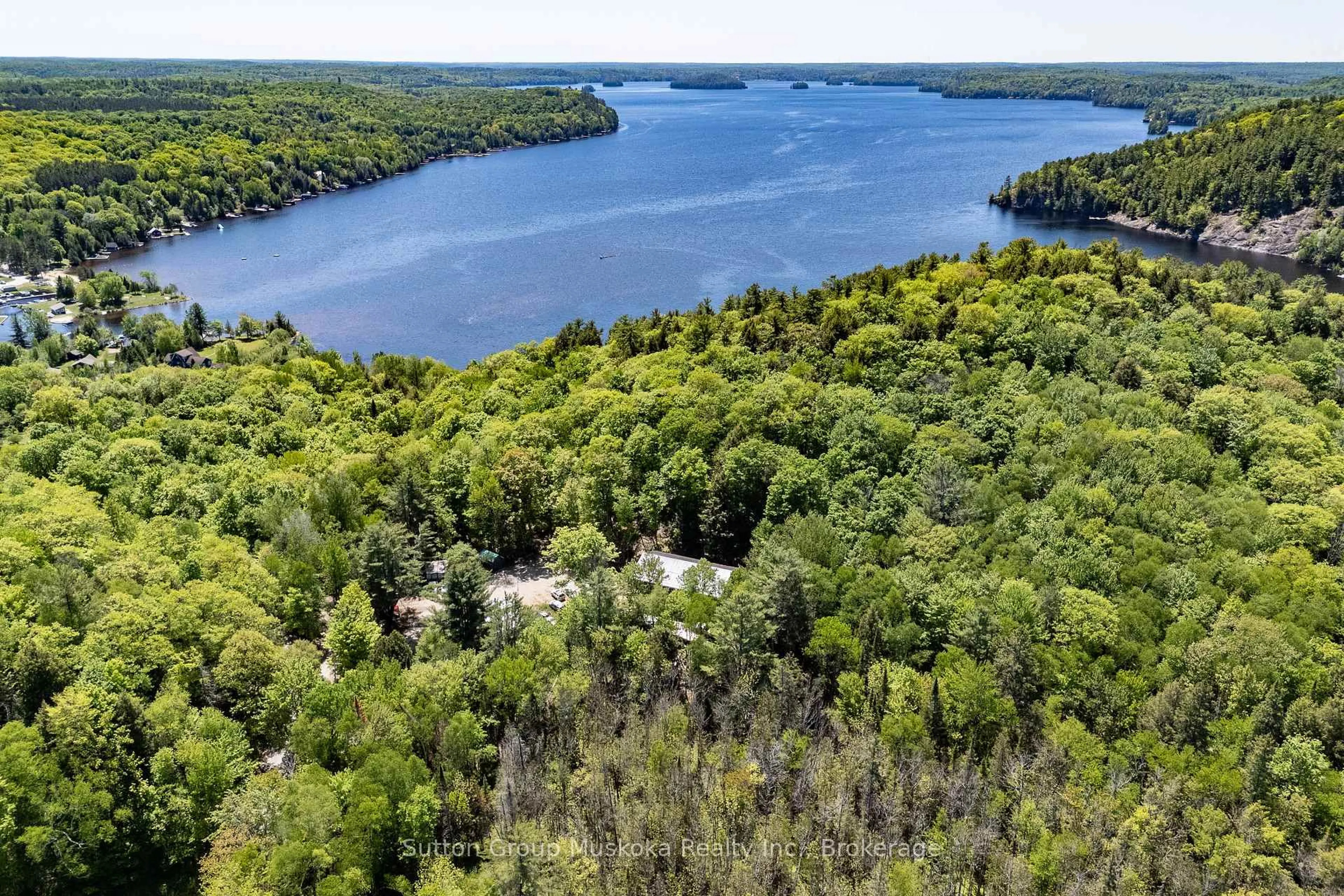 A pic from outside/outdoor area/front of a property/back of a property/a pic from drone, water/lake/river/ocean view for 1467 North Mary Lake Rd, Huntsville Ontario P1H 2J3