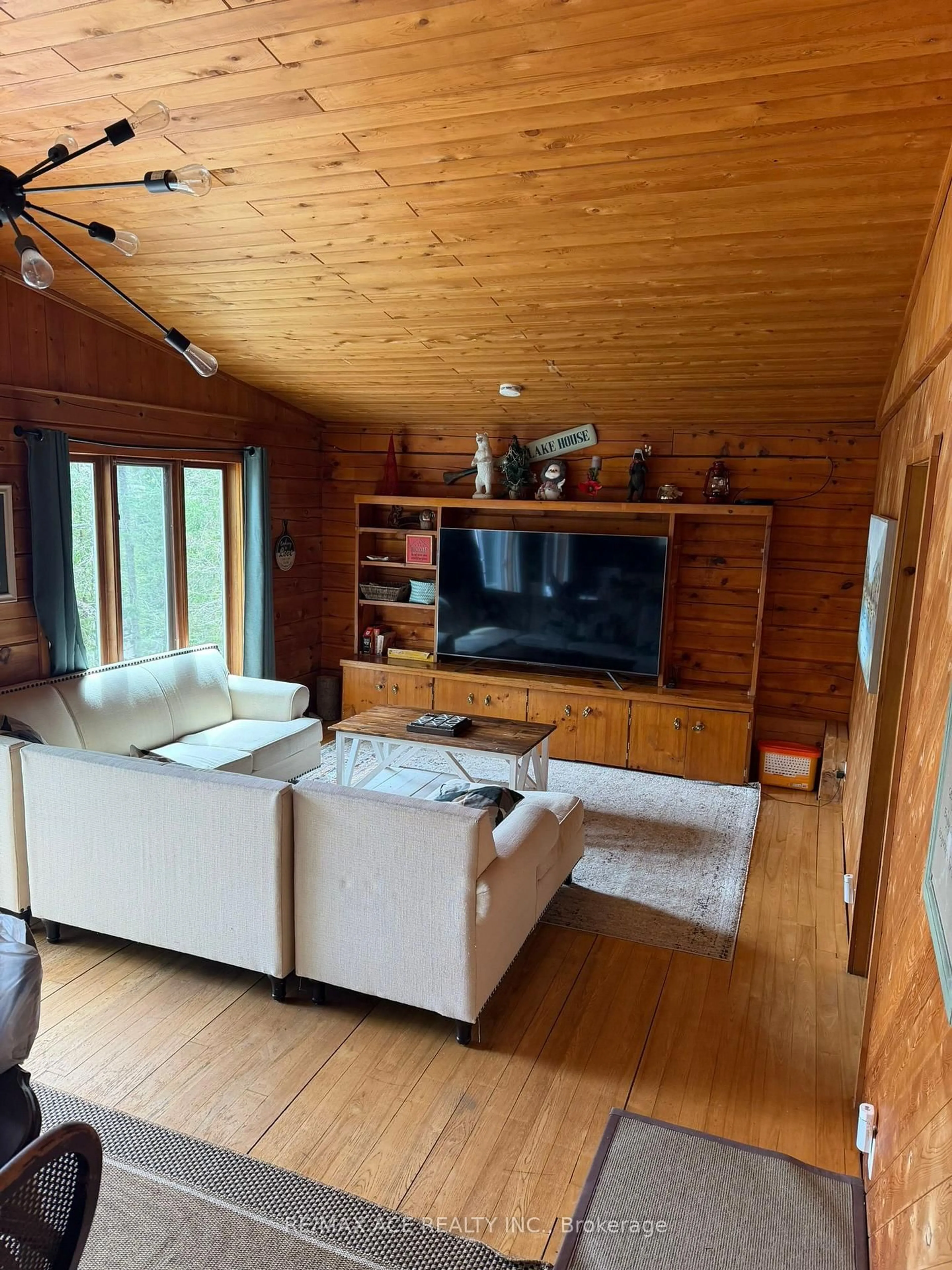 Living room with furniture, wood/laminate floor for 253 Faradale Dr, Bancroft Ontario K0L 1C0