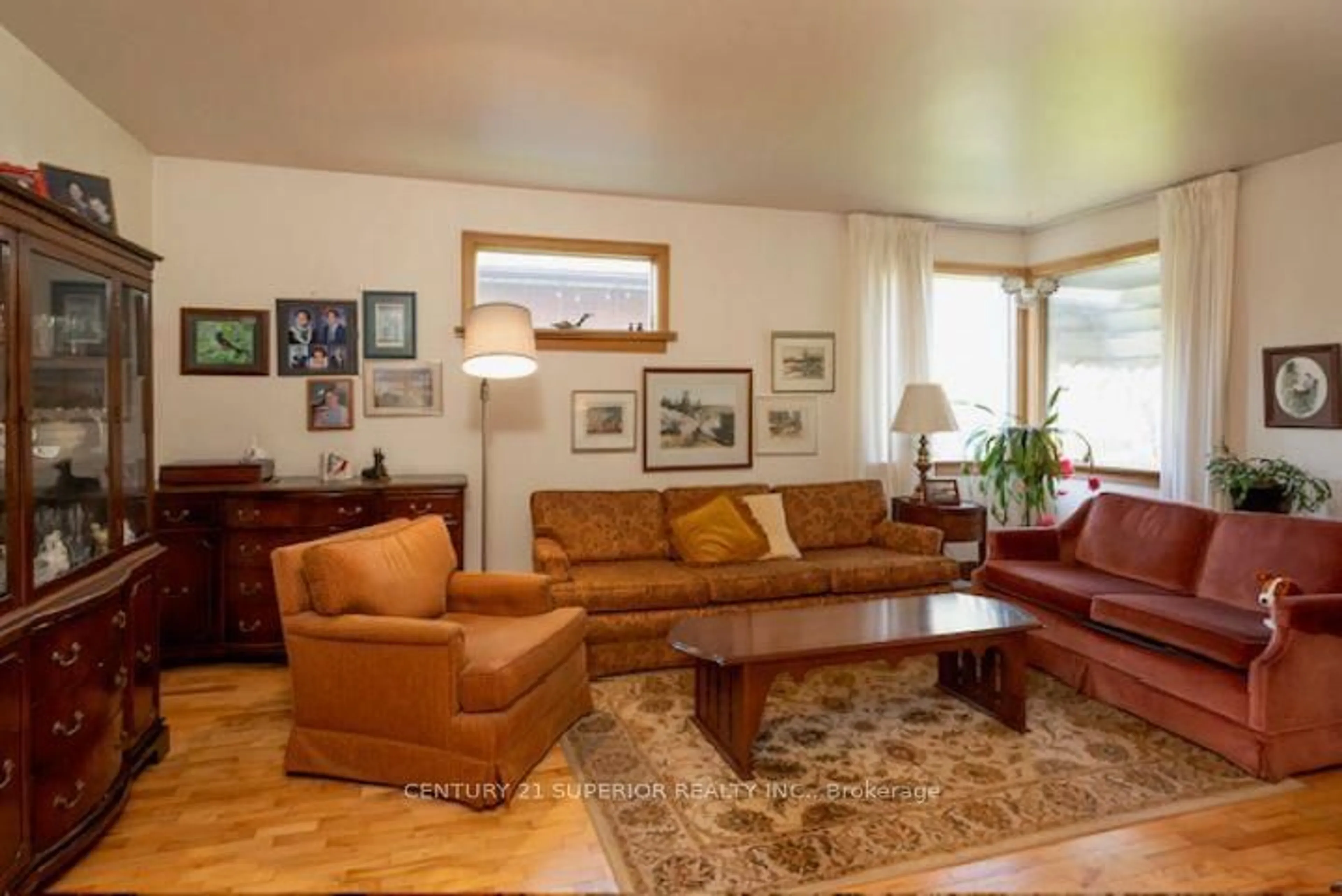 Living room with furniture, wood/laminate floor for 834 Syndicate Ave, Thunder Bay Ontario P7C 3X5