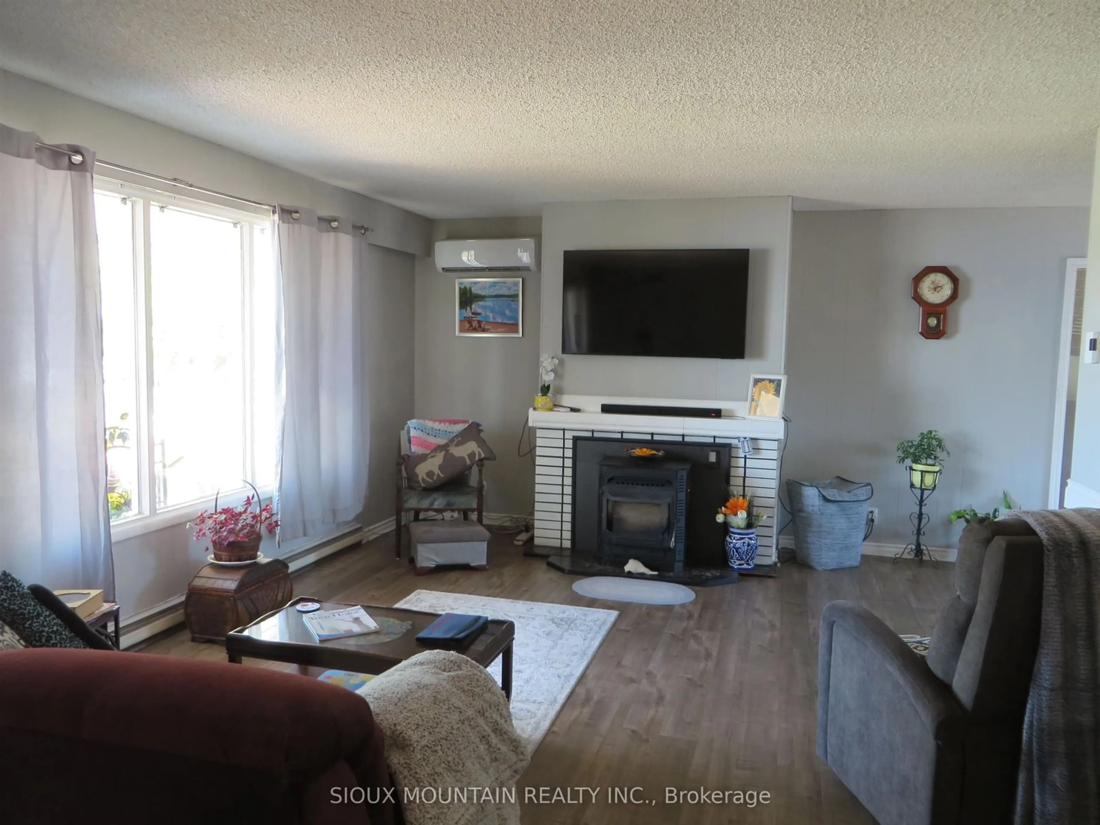 Living room with furniture, wood/laminate floor for 79 Ethel Street, Sioux Lookout Ontario P8T 1E4