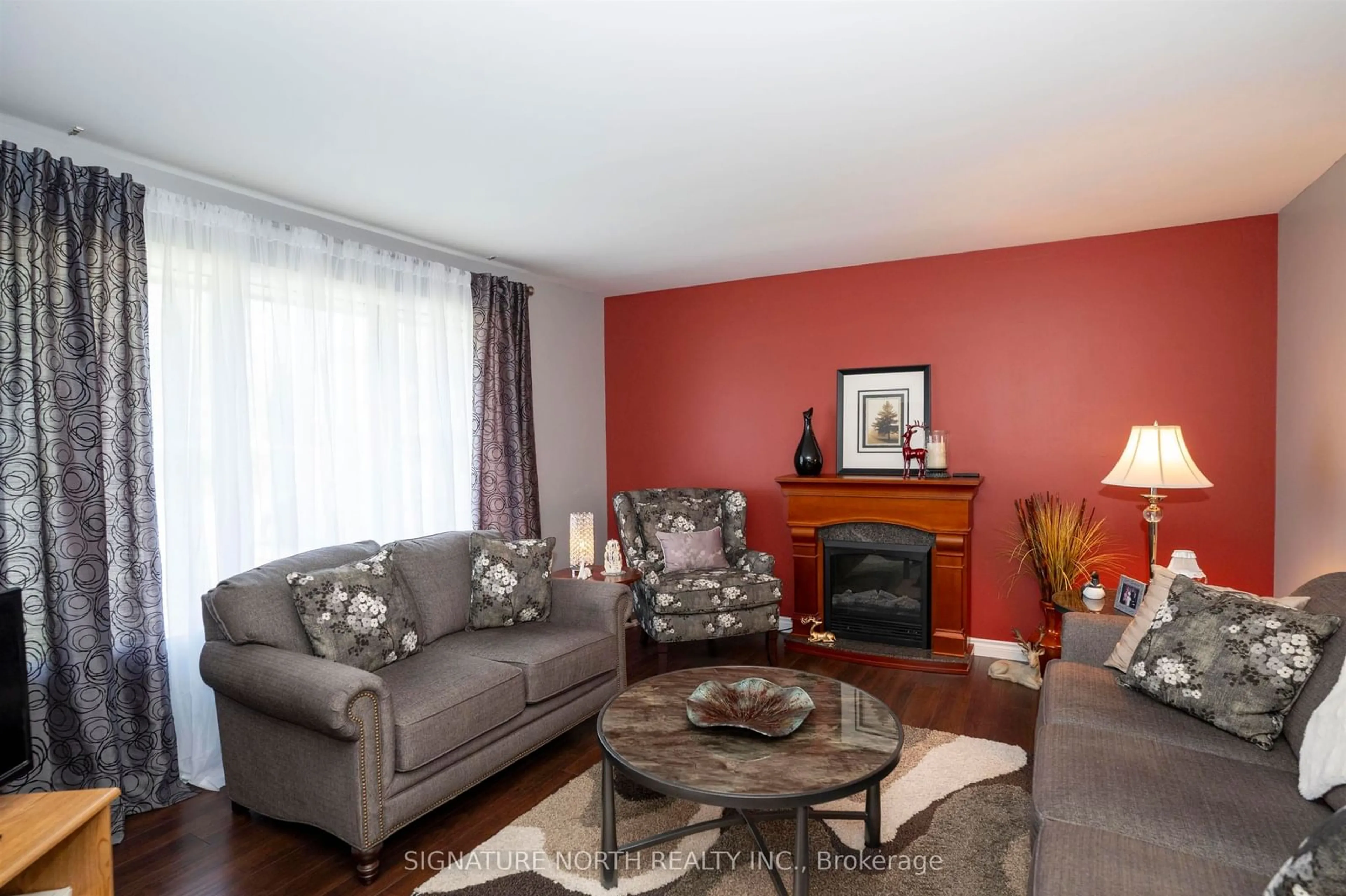 Living room with furniture, wood/laminate floor for 381 Hallam St, Thunder Bay Ontario P7A 1M2