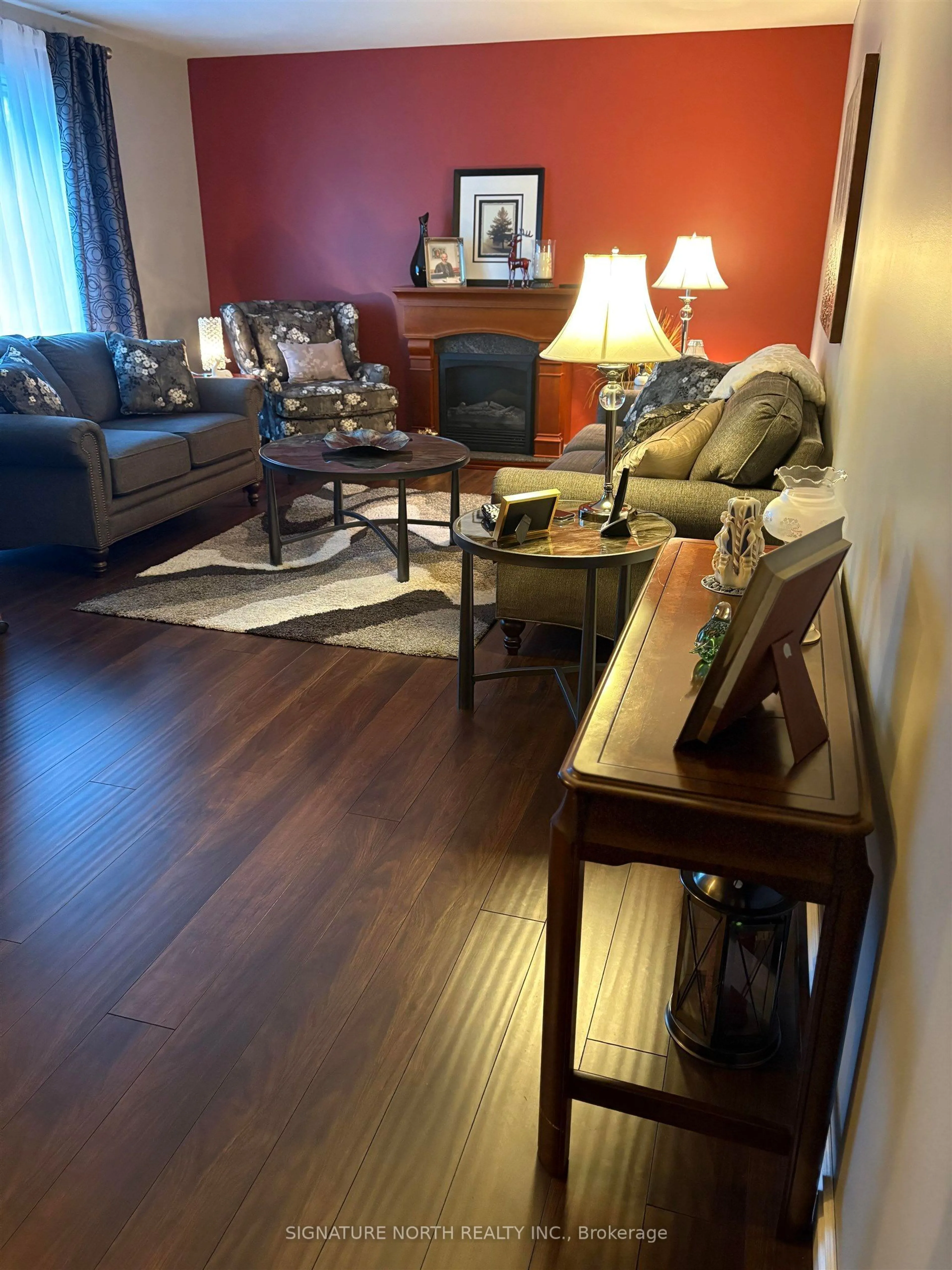 Living room with furniture, wood/laminate floor for 381 Hallam St, Thunder Bay Ontario P7A 1M2