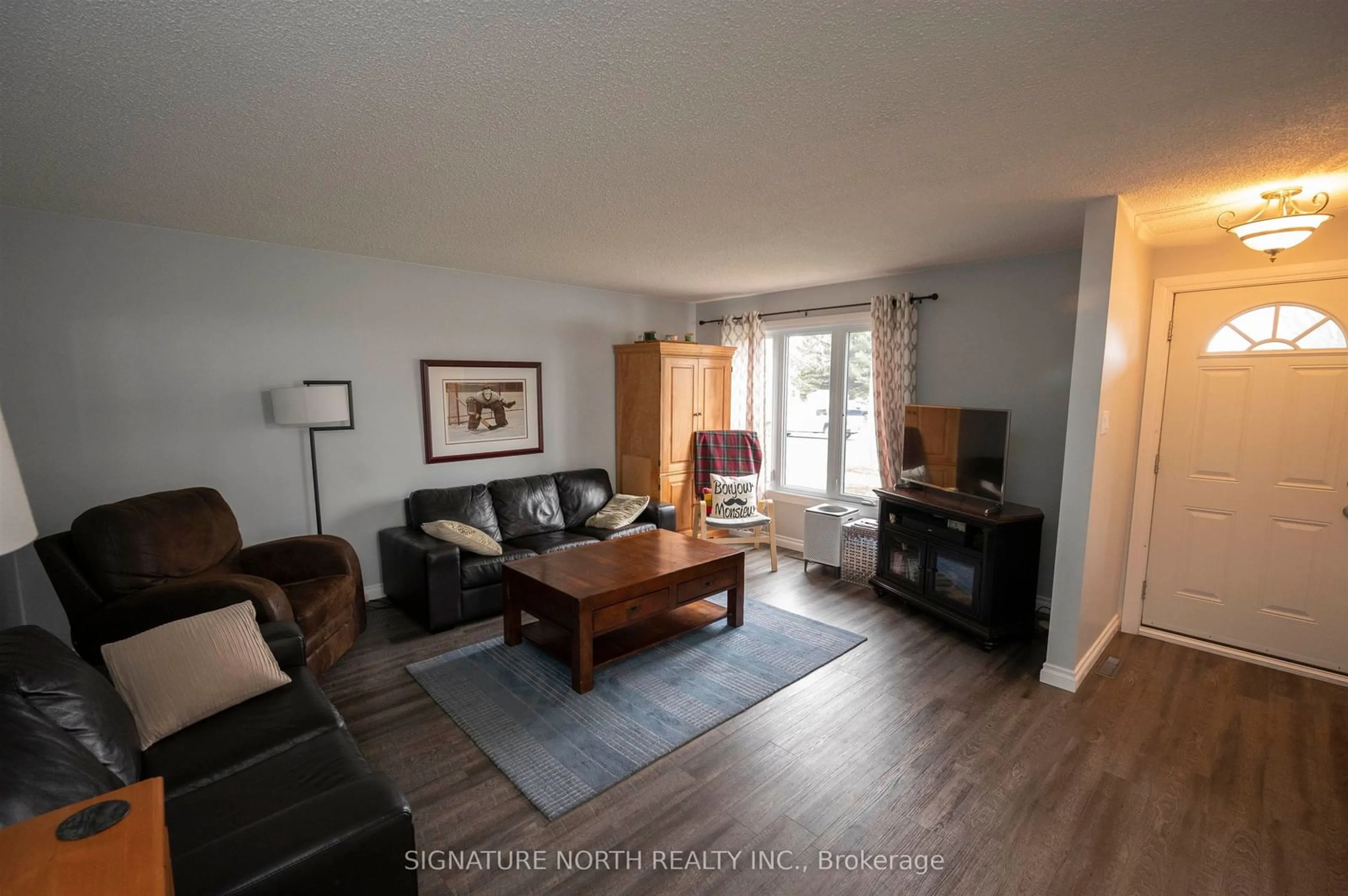Living room with furniture, wood/laminate floor for 233 Edward Street North, Thunder Bay Ontario P7C 4P1