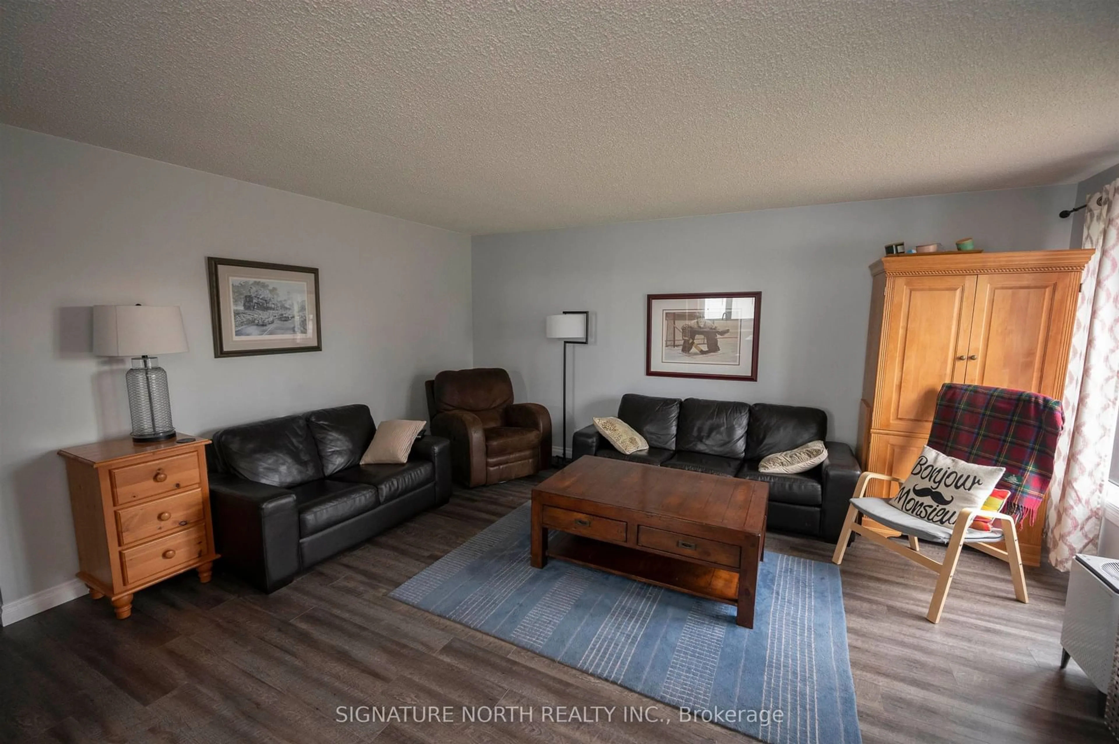 Living room with furniture, wood/laminate floor for 233 Edward Street North, Thunder Bay Ontario P7C 4P1
