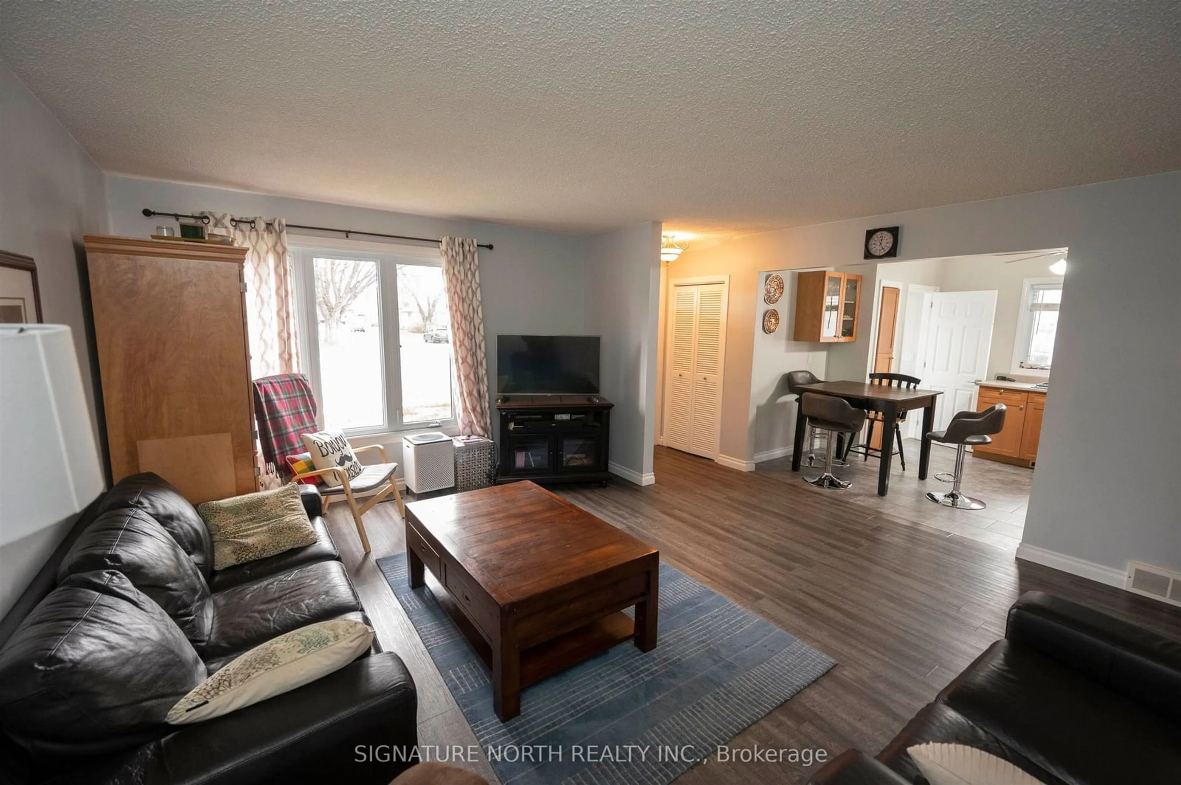 Living room with furniture, wood/laminate floor for 233 Edward Street North, Thunder Bay Ontario P7C 4P1