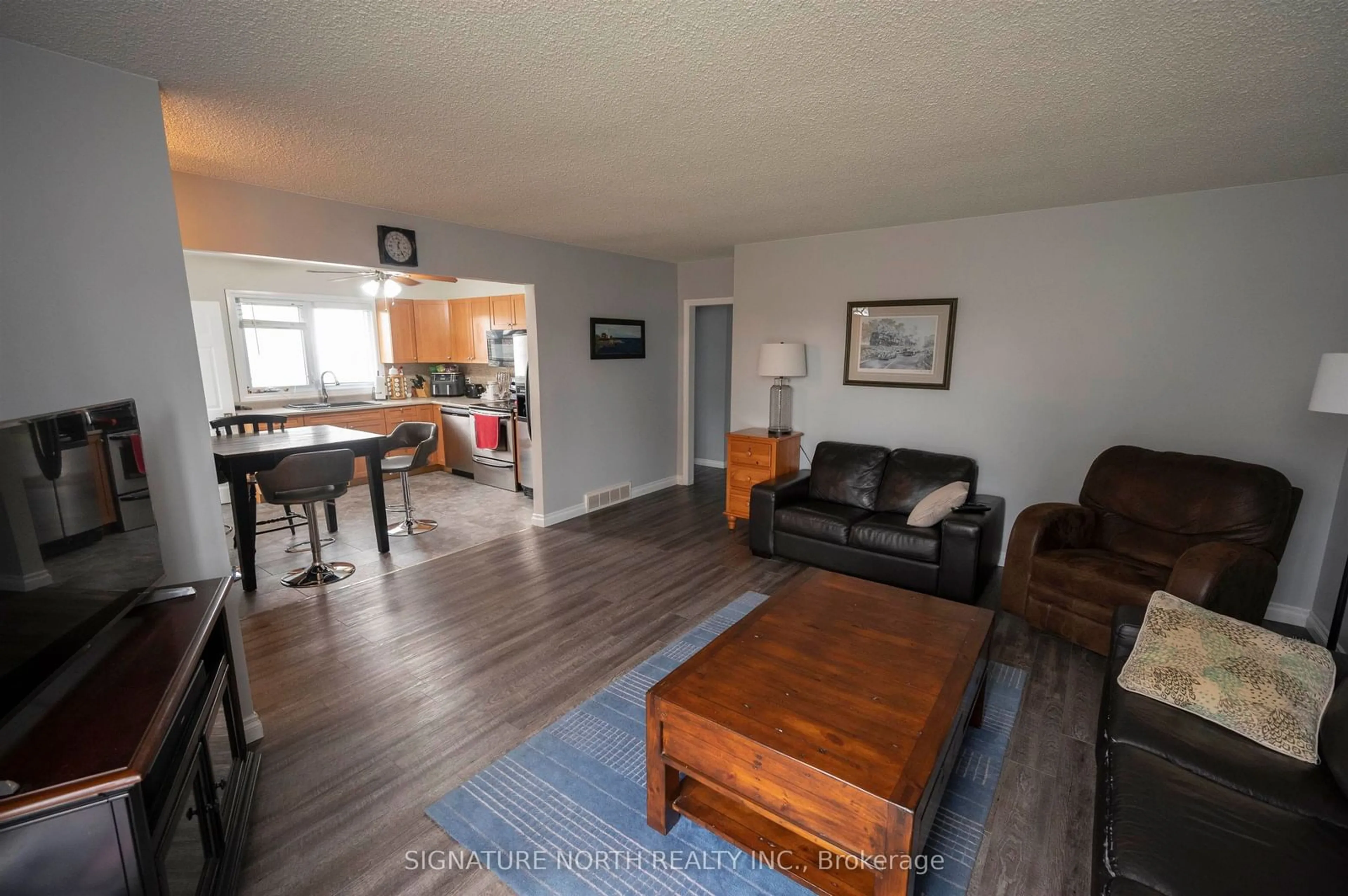 Living room with furniture, wood/laminate floor for 233 Edward Street North, Thunder Bay Ontario P7C 4P1