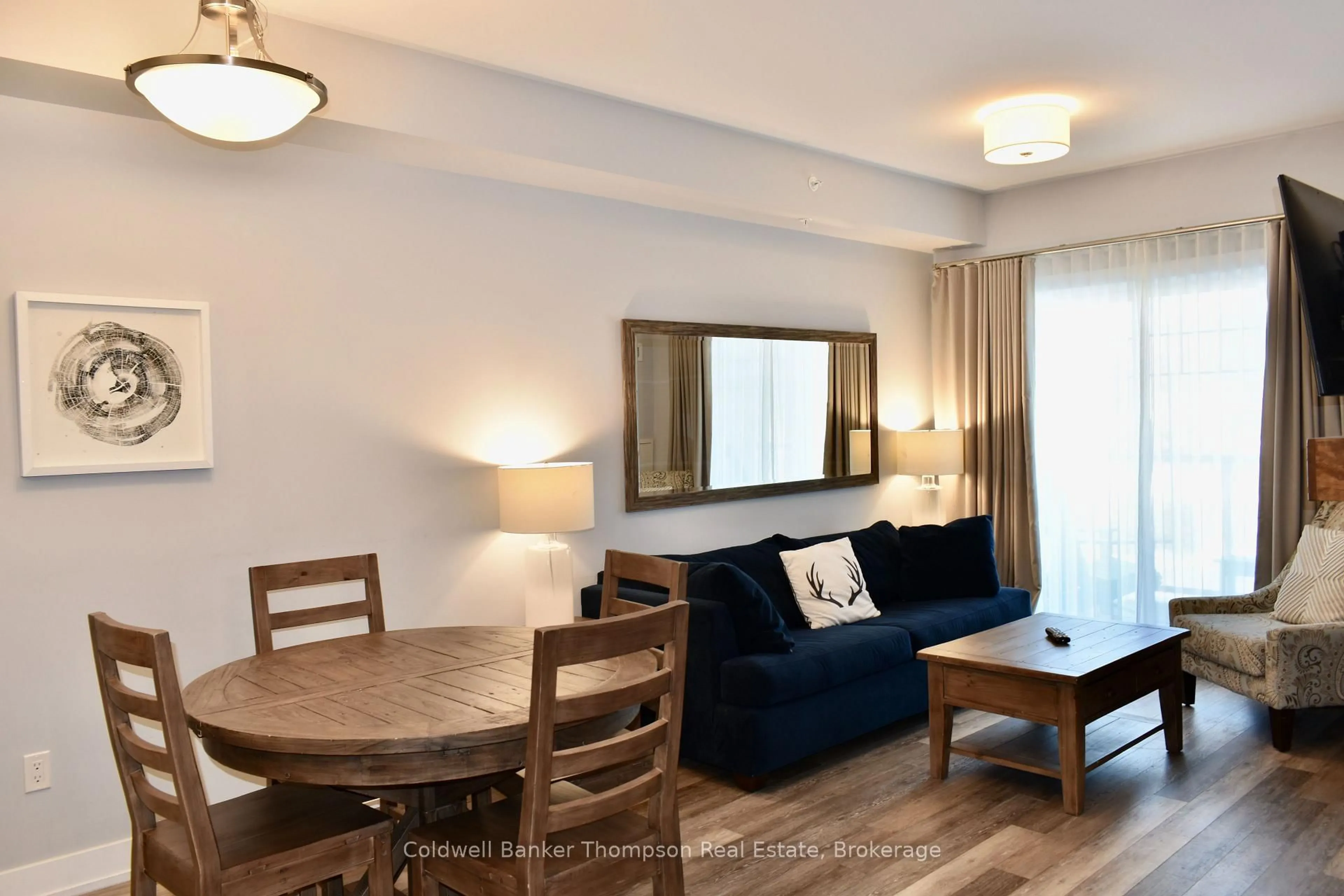 Living room with furniture, wood/laminate floor for 25 PEN LAKE POINT Rd #328, Huntsville Ontario P1H 1A9