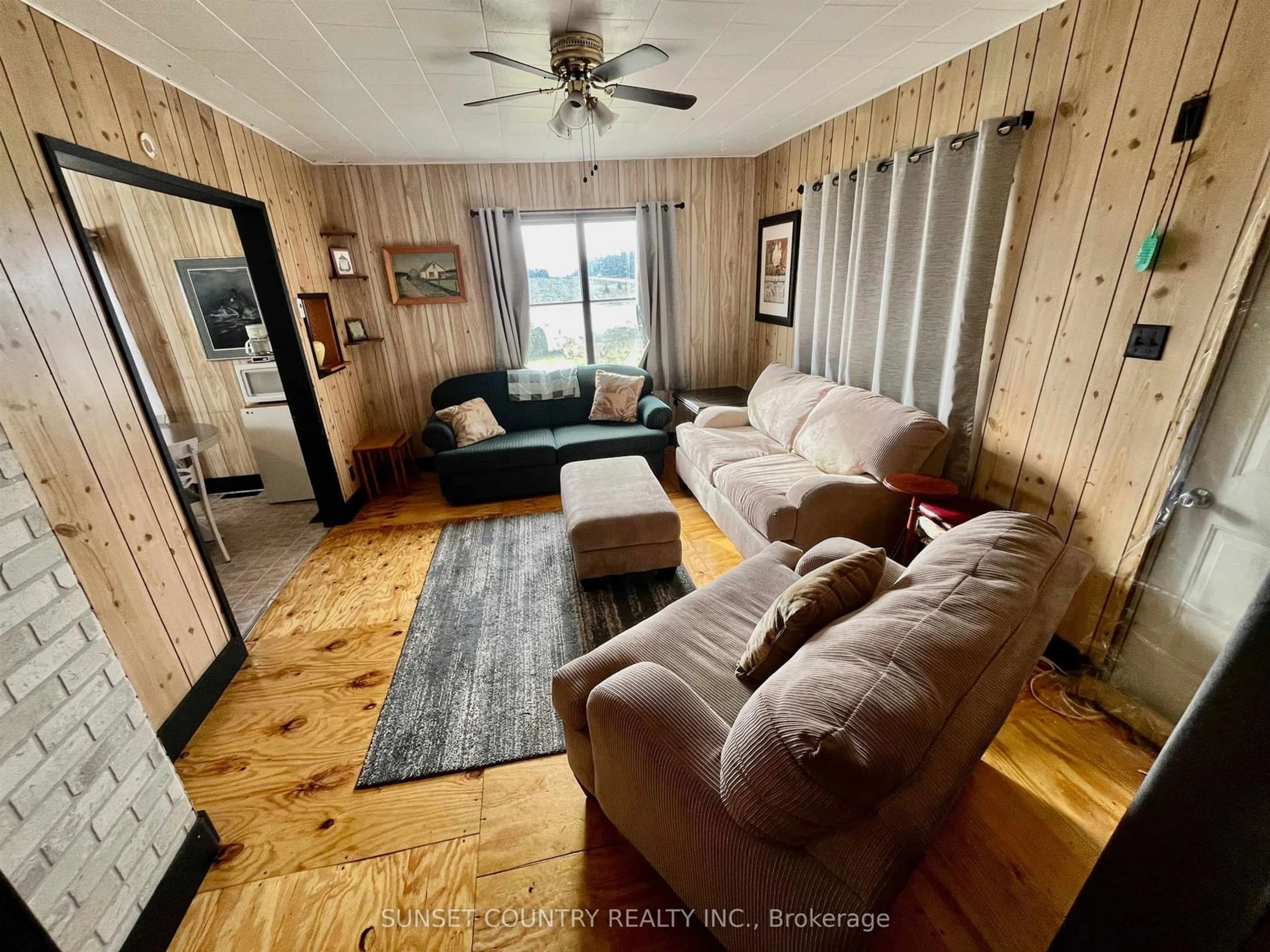 Living room with furniture, wood/laminate floor for 2541 HWY 105, Kenora Remote Area Ontario P0V 2V0