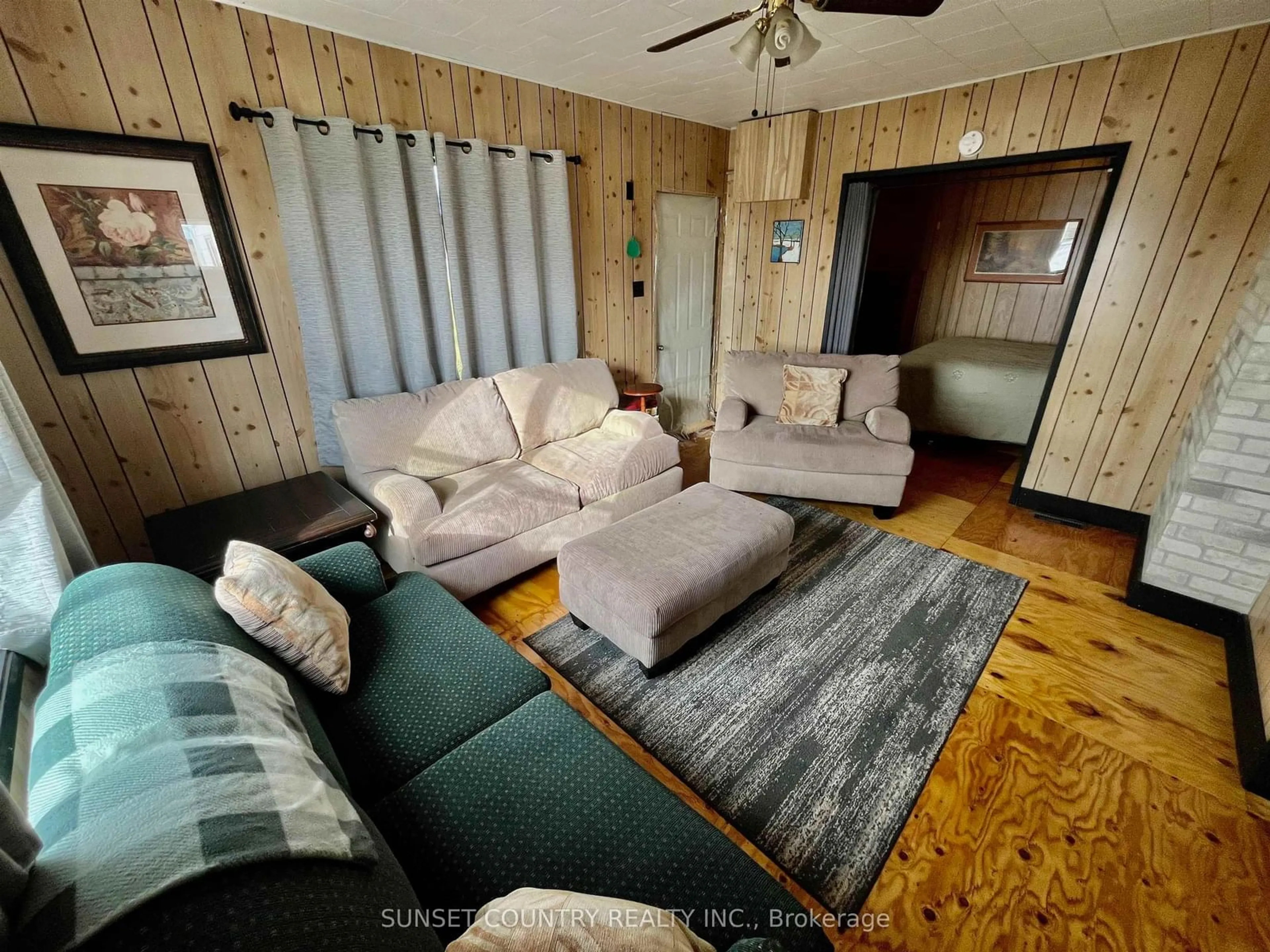 Living room with furniture, wood/laminate floor for 2541 HWY 105, Kenora Remote Area Ontario P0V 2V0