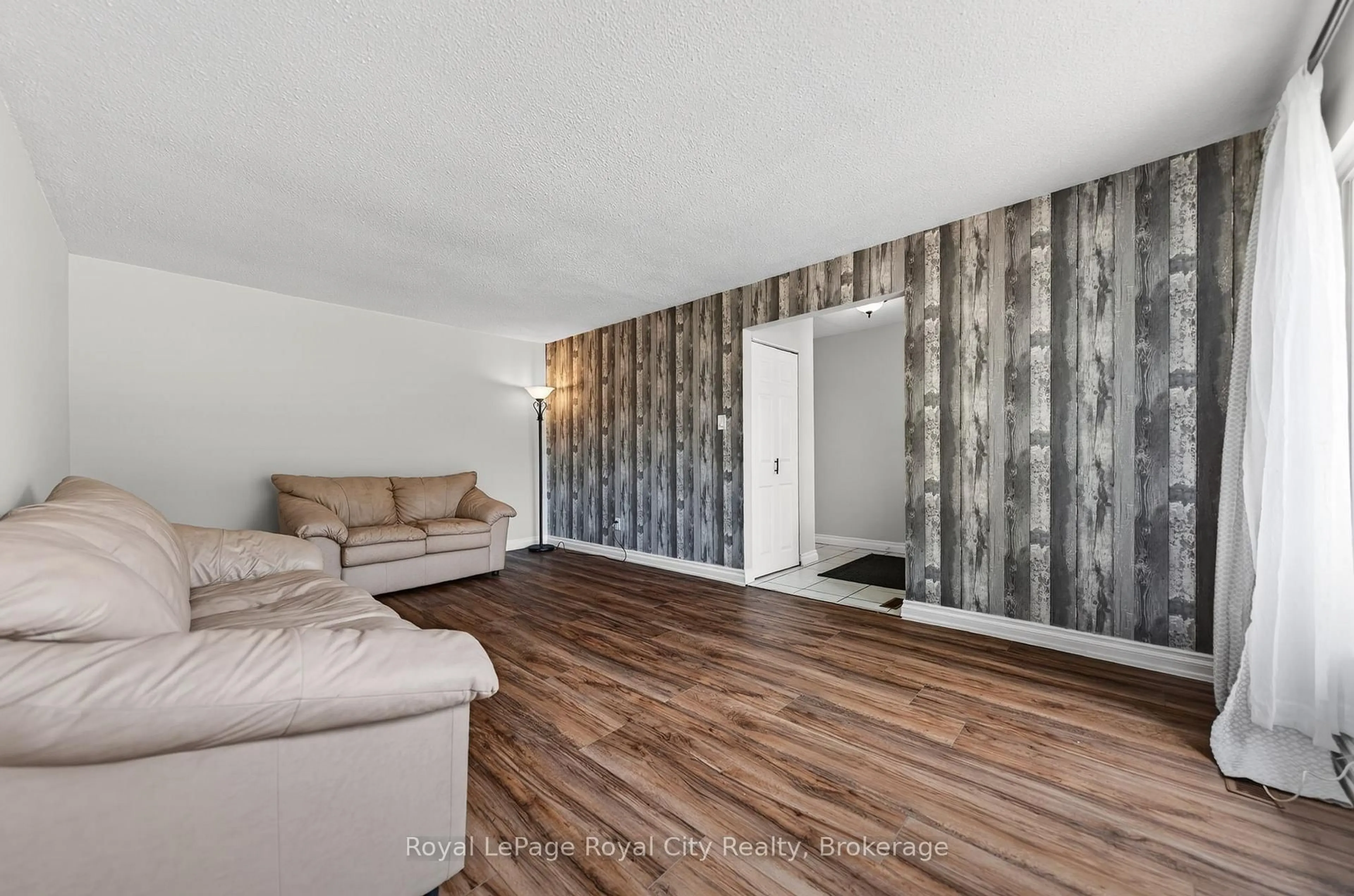 Living room with furniture, wood/laminate floor for 35 Eastview Rd, Guelph Ontario N1E 6J7