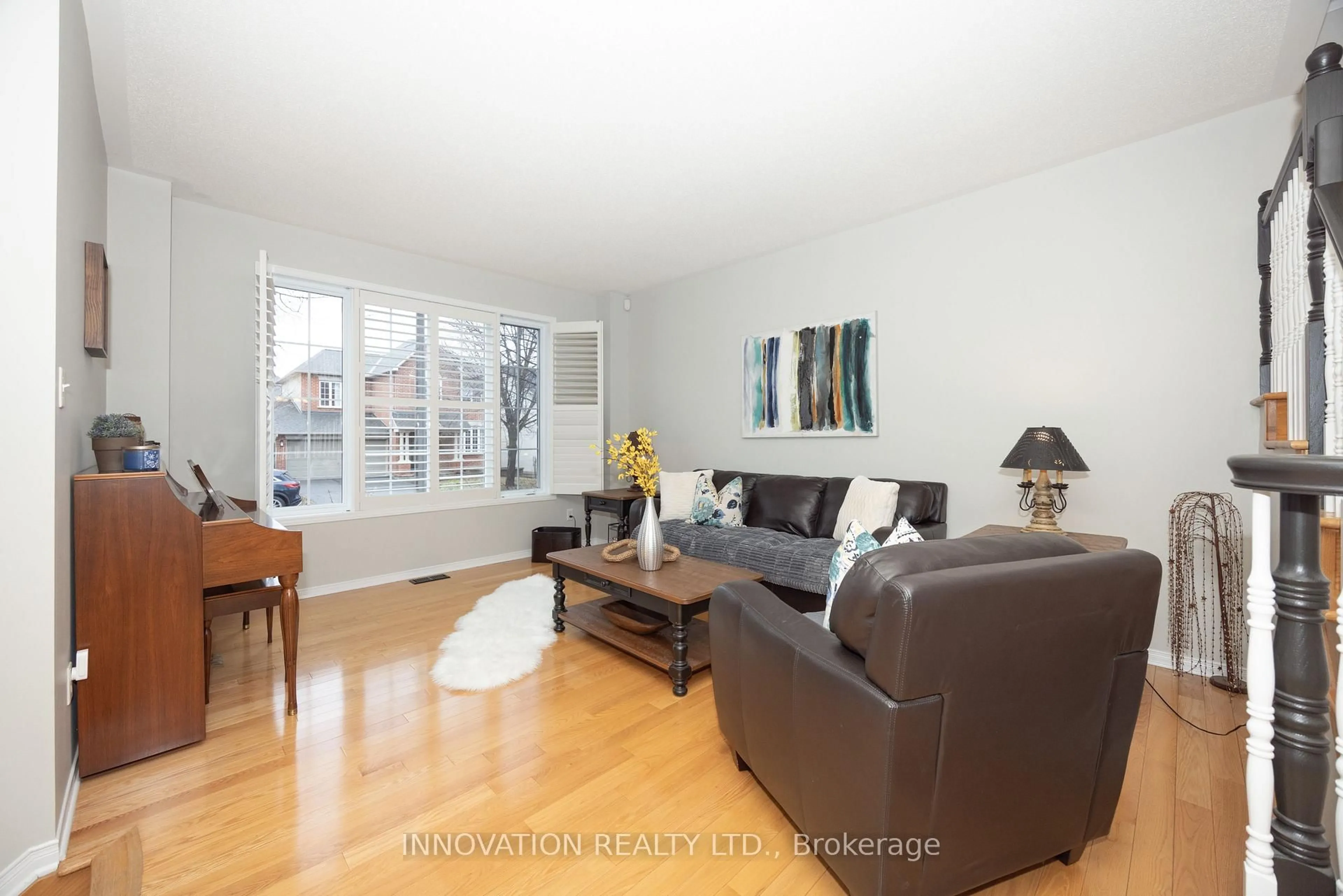 Living room with furniture, wood/laminate floor for 15 Whithorn Ave, Kanata Ontario K2K 3B2