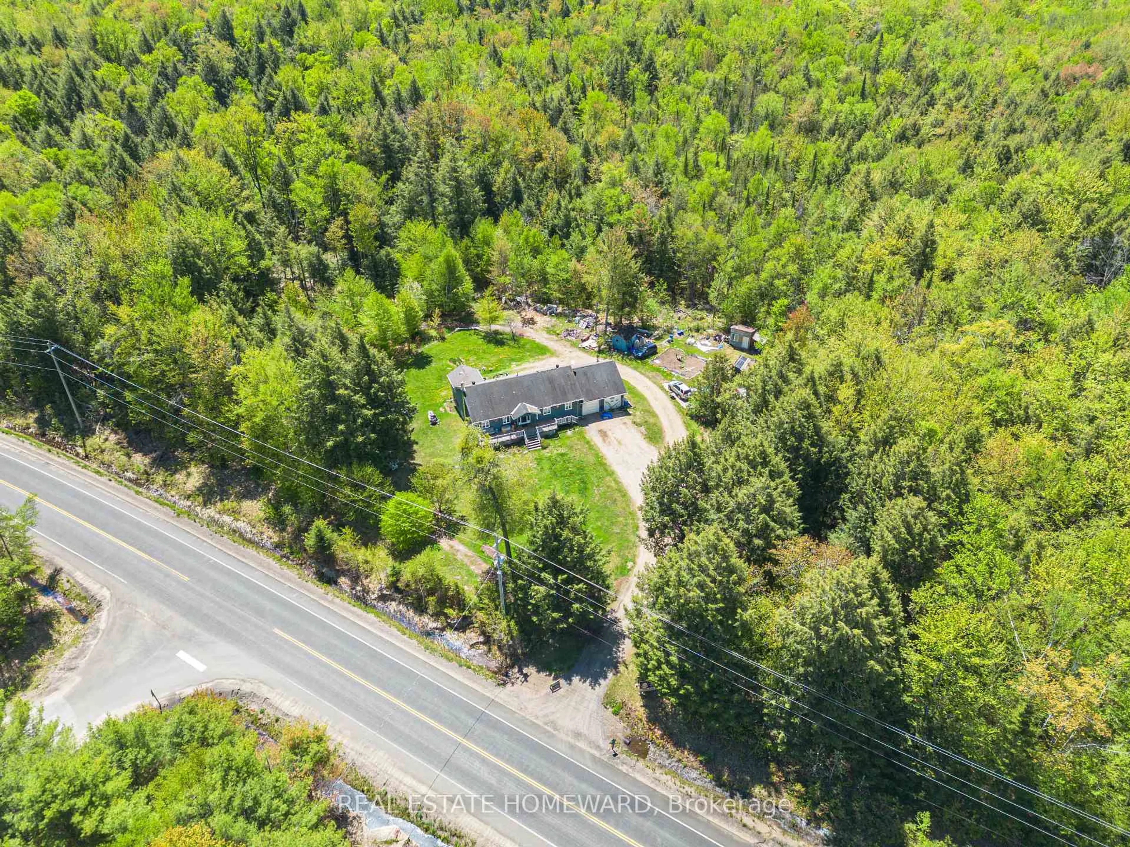A pic from outside/outdoor area/front of a property/back of a property/a pic from drone, forest/trees view for 2928 118 Highway, Bracebridge Ontario P1P 1R3