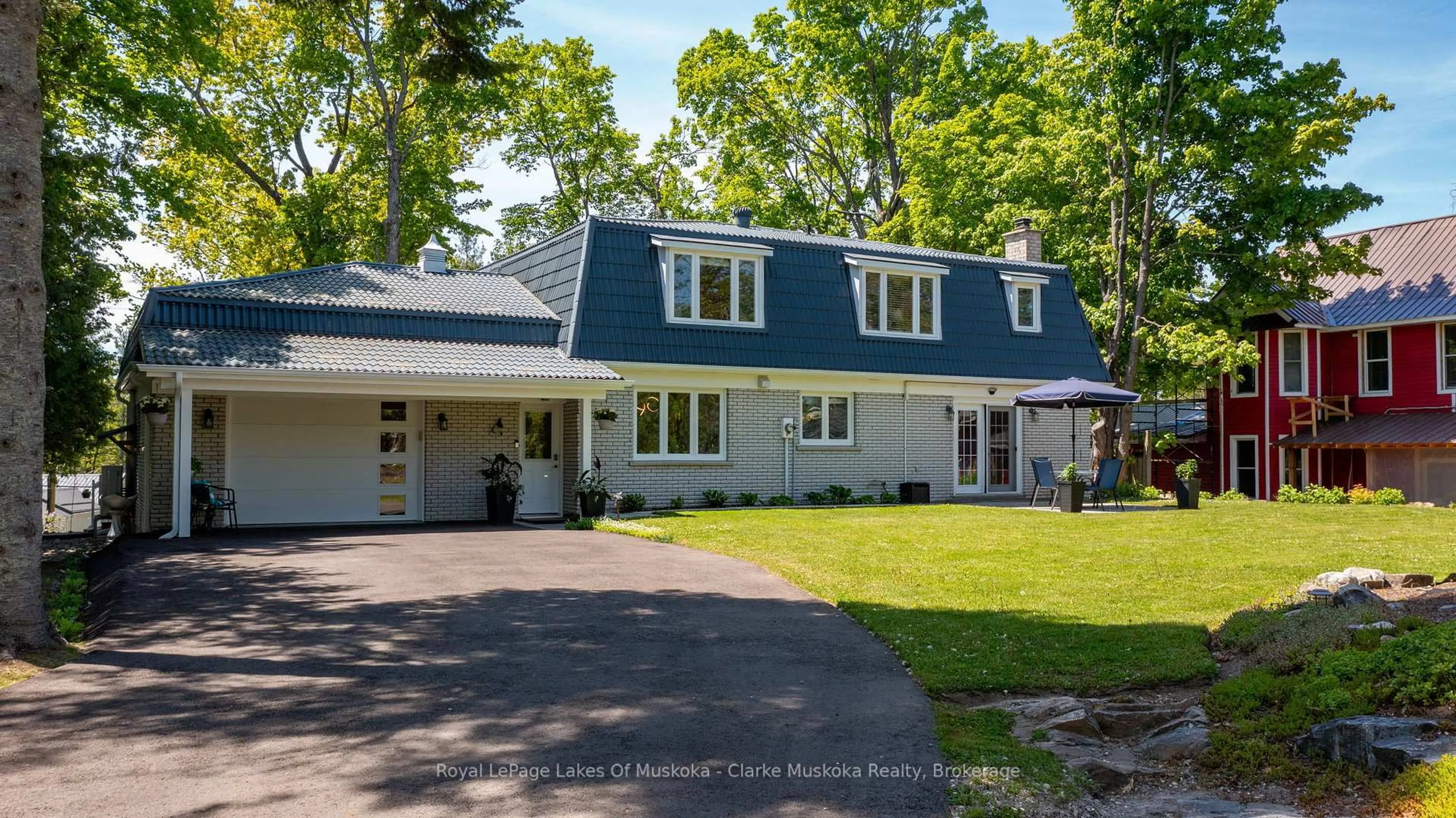 Home with vinyl exterior material, street for 1012 Mill St, Muskoka Lakes Ontario P0C 1A0