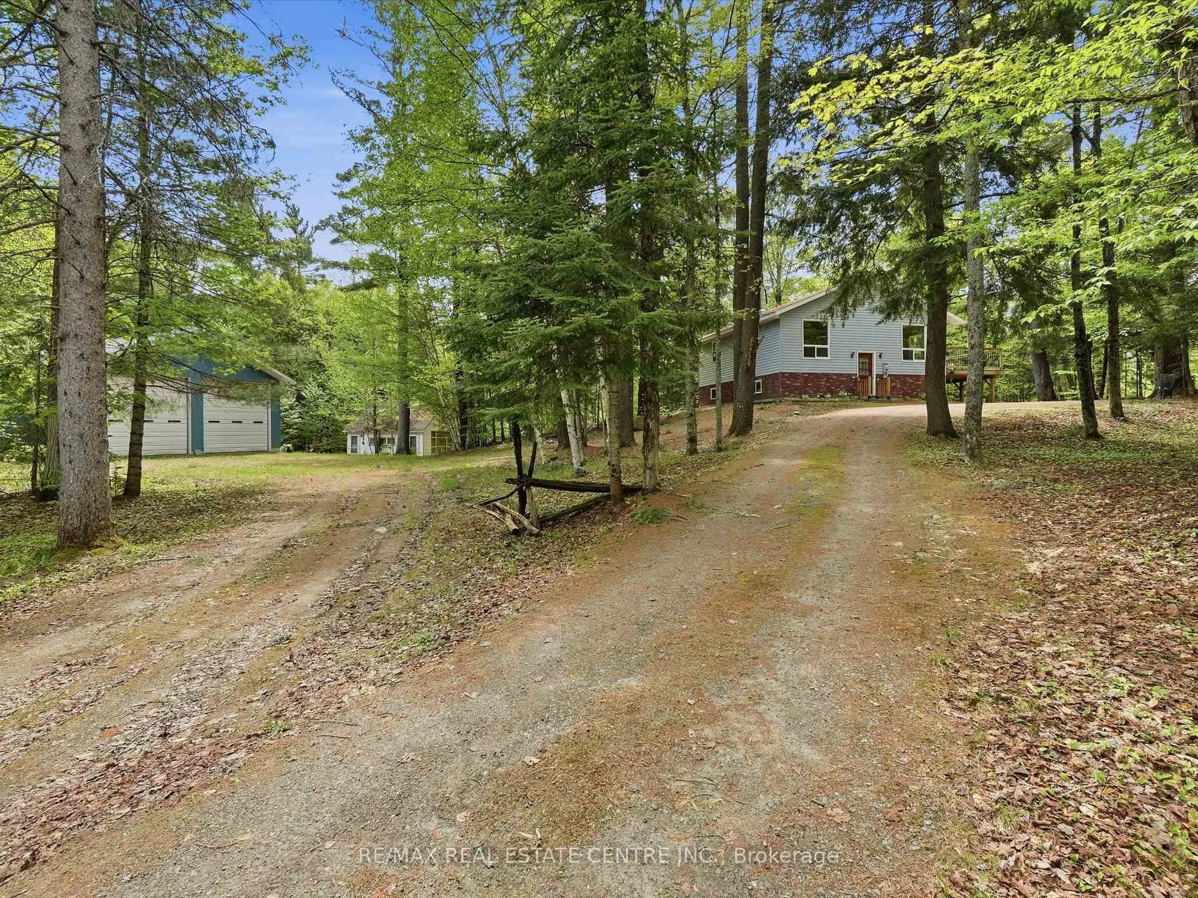 A pic from outside/outdoor area/front of a property/back of a property/a pic from drone, forest/trees view for 1059 Britannia Rd, Huntsville Ontario P1H 2J3