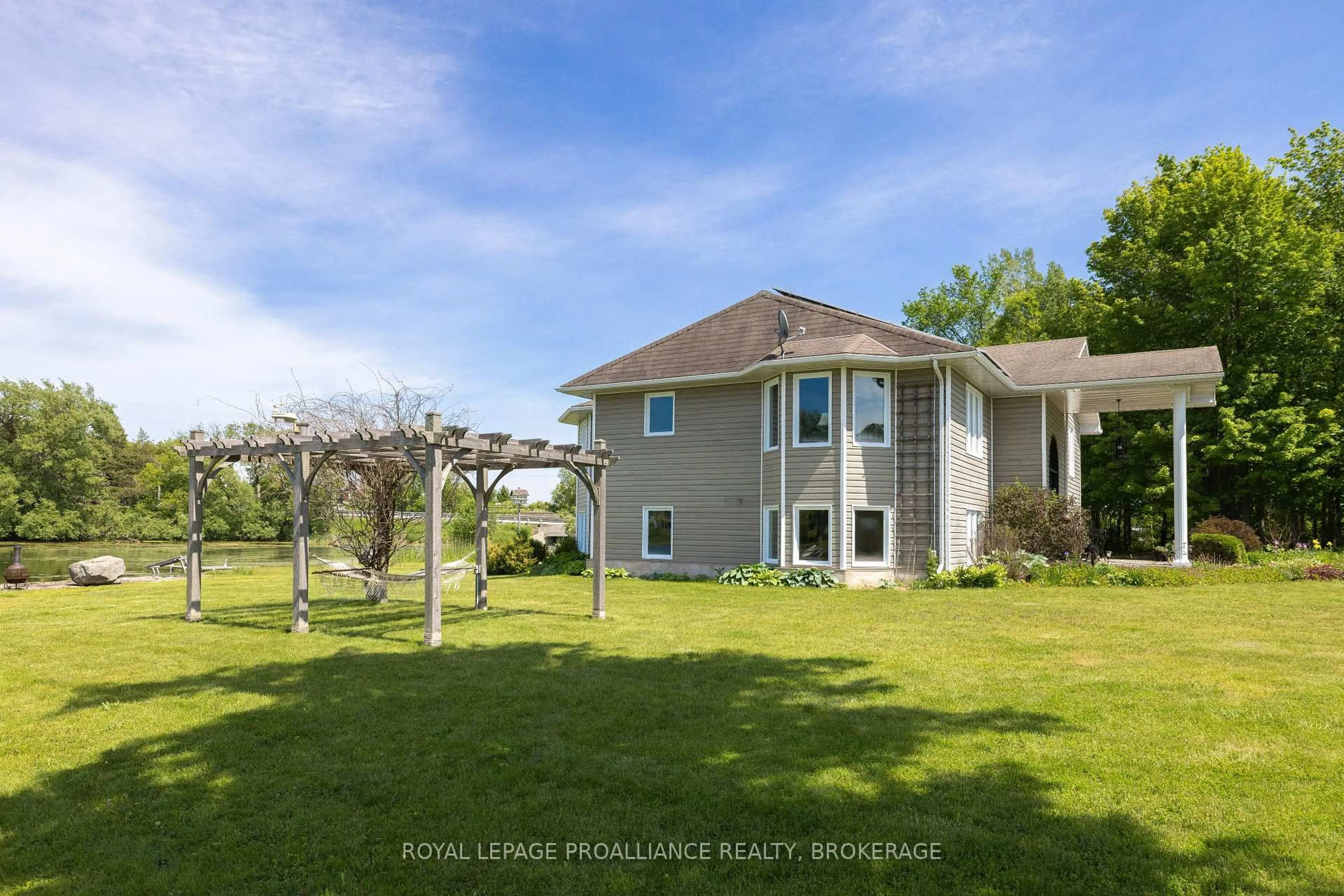 A pic from outside/outdoor area/front of a property/back of a property/a pic from drone, water/lake/river/ocean view for 2318 15 Highway, Kingston Ontario K7L 4V3