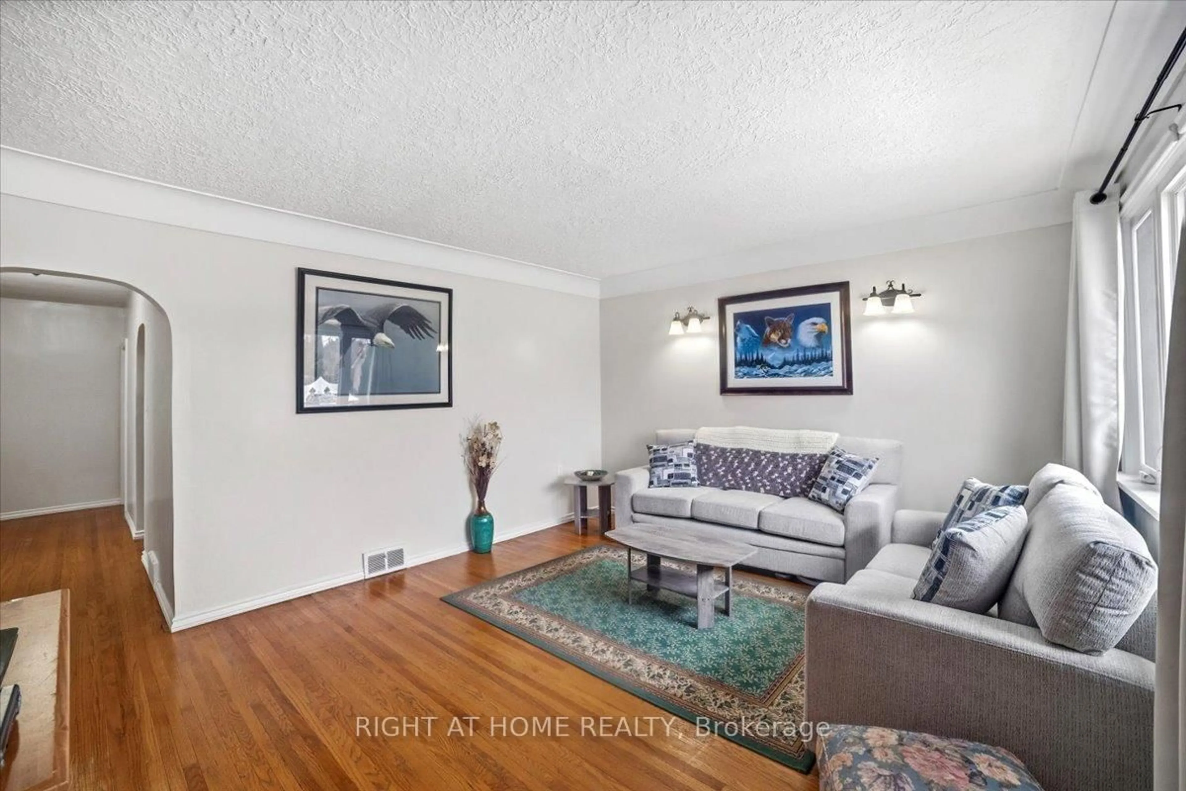 Living room with furniture, wood/laminate floor for 12 Vera St, St. Catharines Ontario L2S 1C4