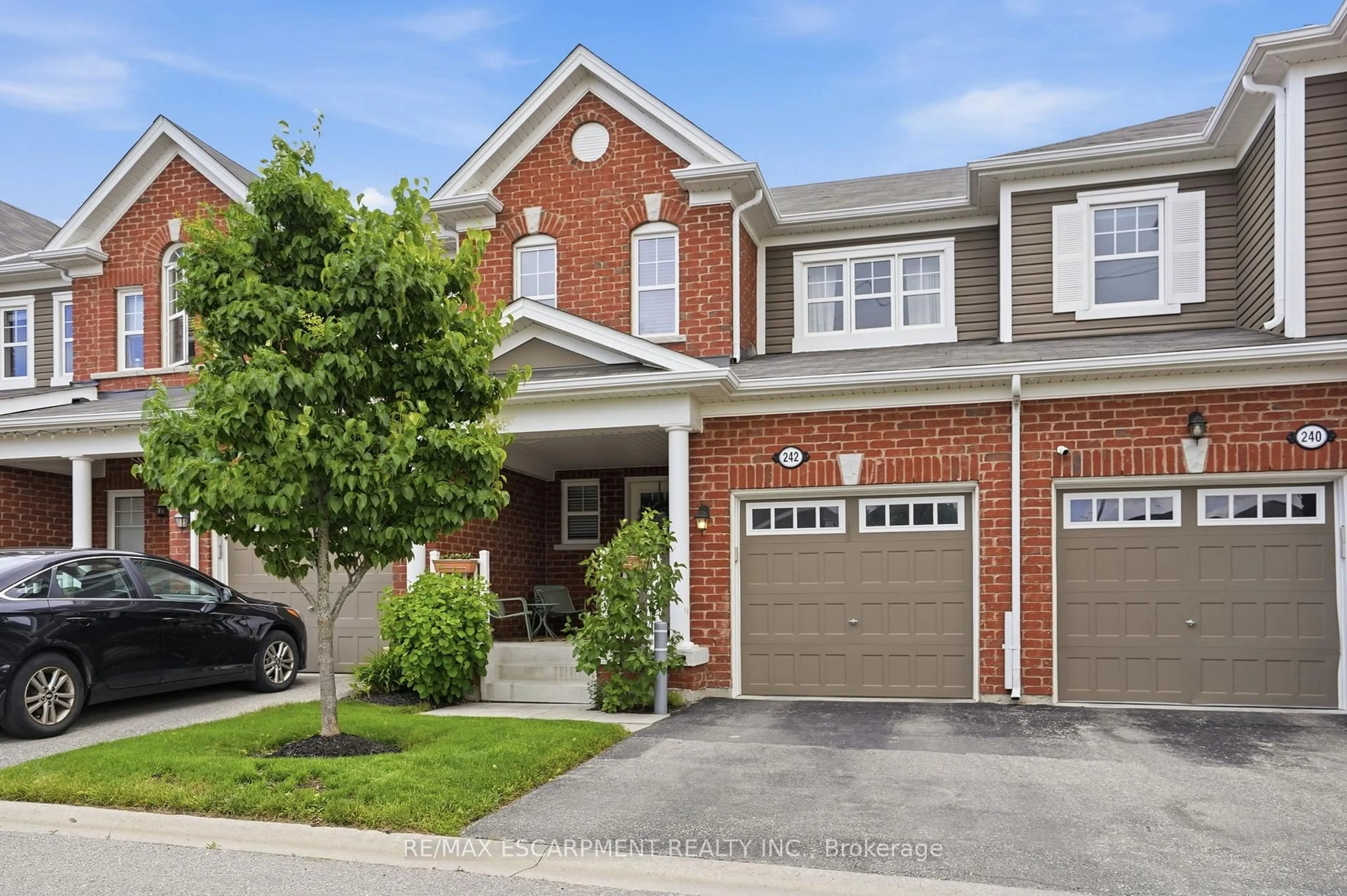 Home with brick exterior material, street for 242 Waterbrook Lane, Kitchener Ontario N2P 0H7