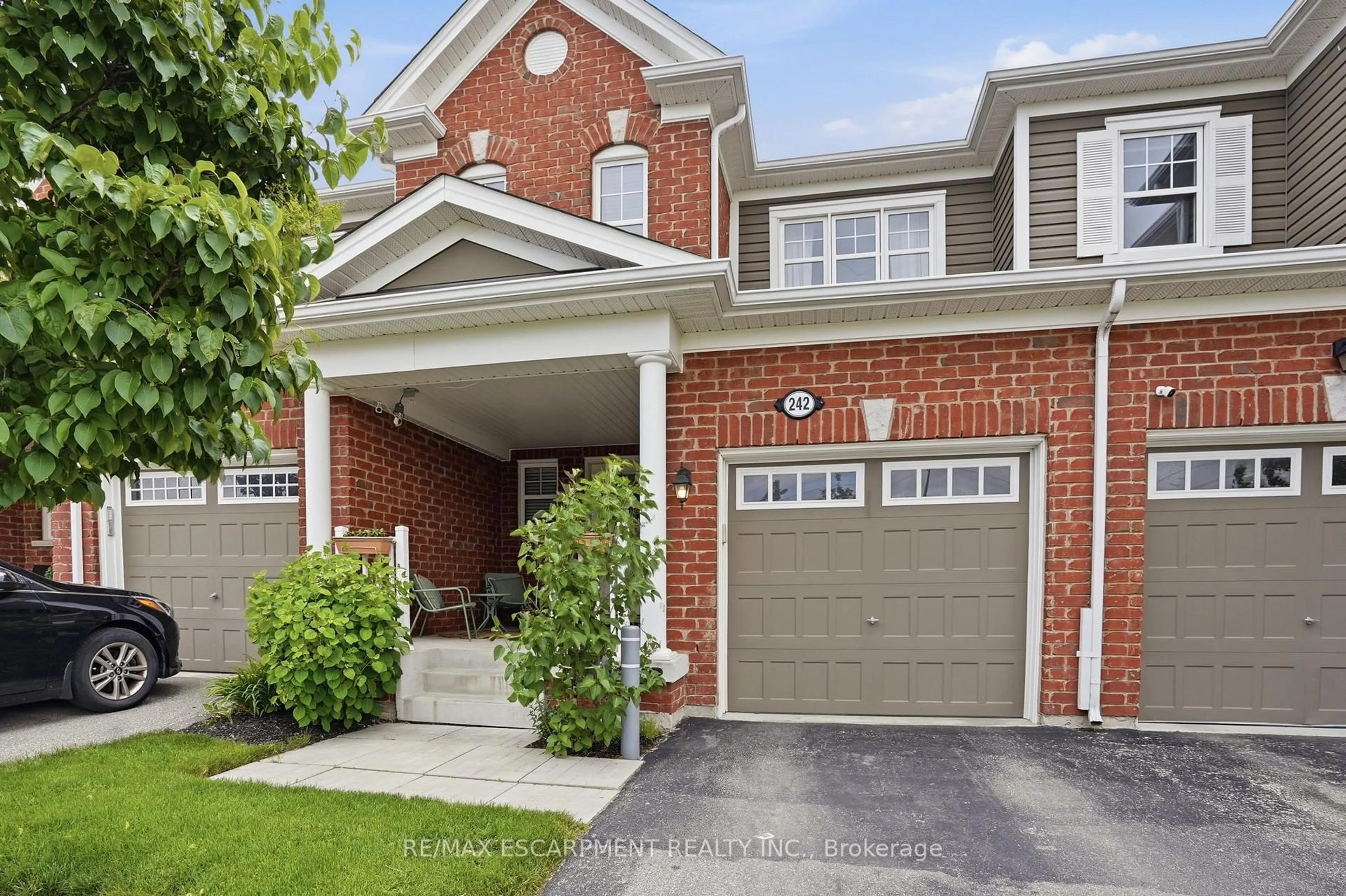 Home with brick exterior material, street for 242 Waterbrook Lane, Kitchener Ontario N2P 0H7