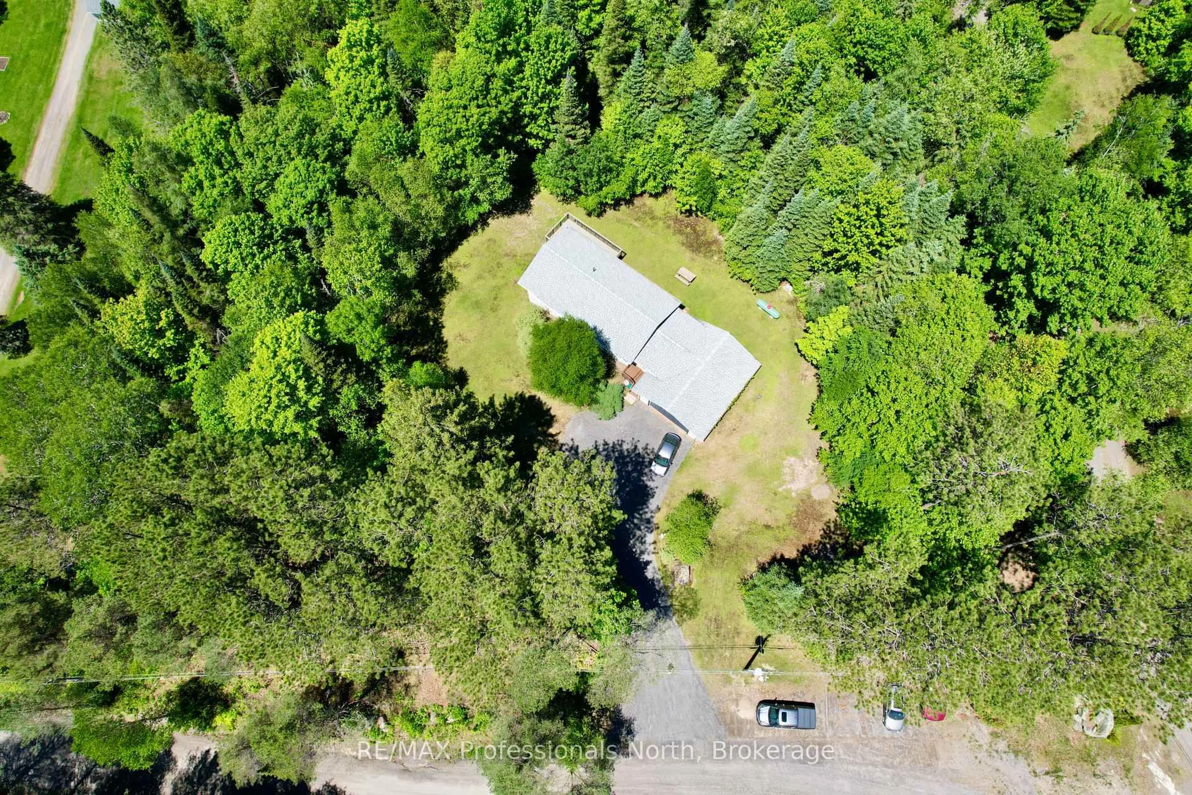 A pic from outside/outdoor area/front of a property/back of a property/a pic from drone, forest/trees view for 86 Bottings Rd, Huntsville Ontario P0B 1M0