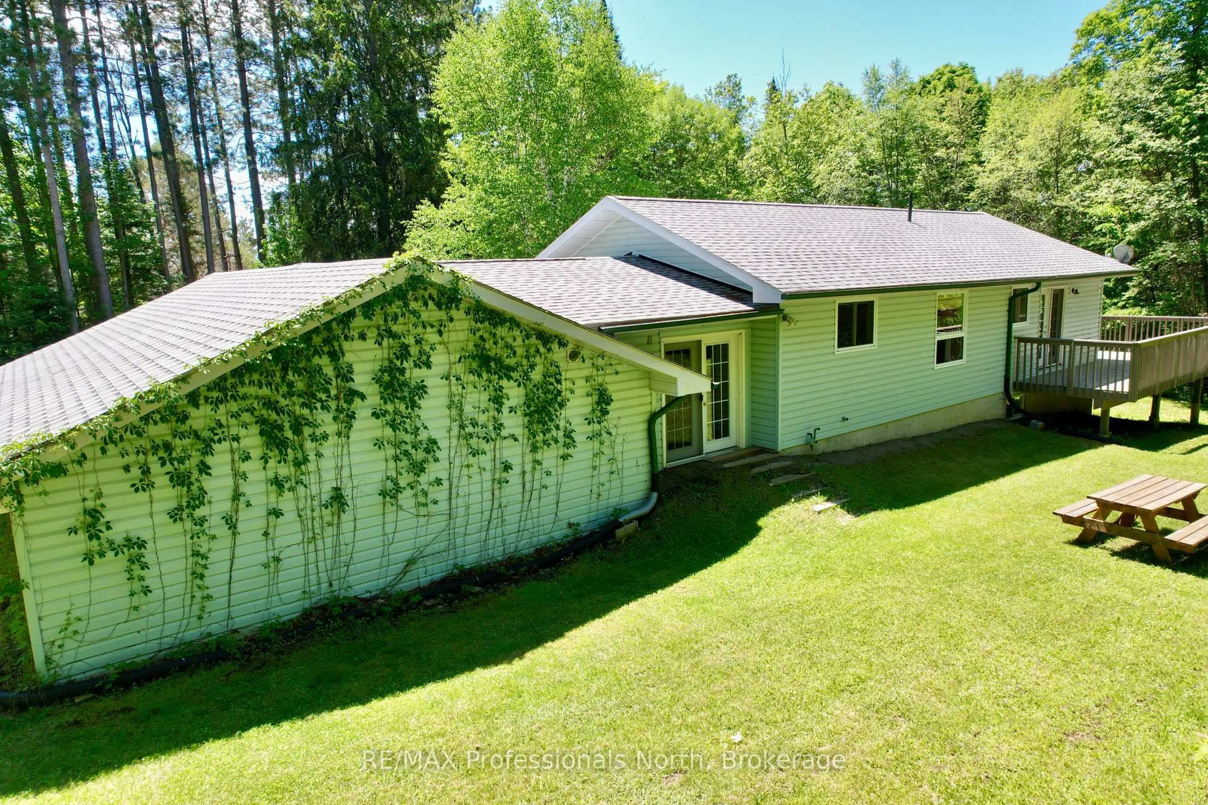 A pic from outside/outdoor area/front of a property/back of a property/a pic from drone, forest/trees view for 86 Bottings Rd, Huntsville Ontario P0B 1M0