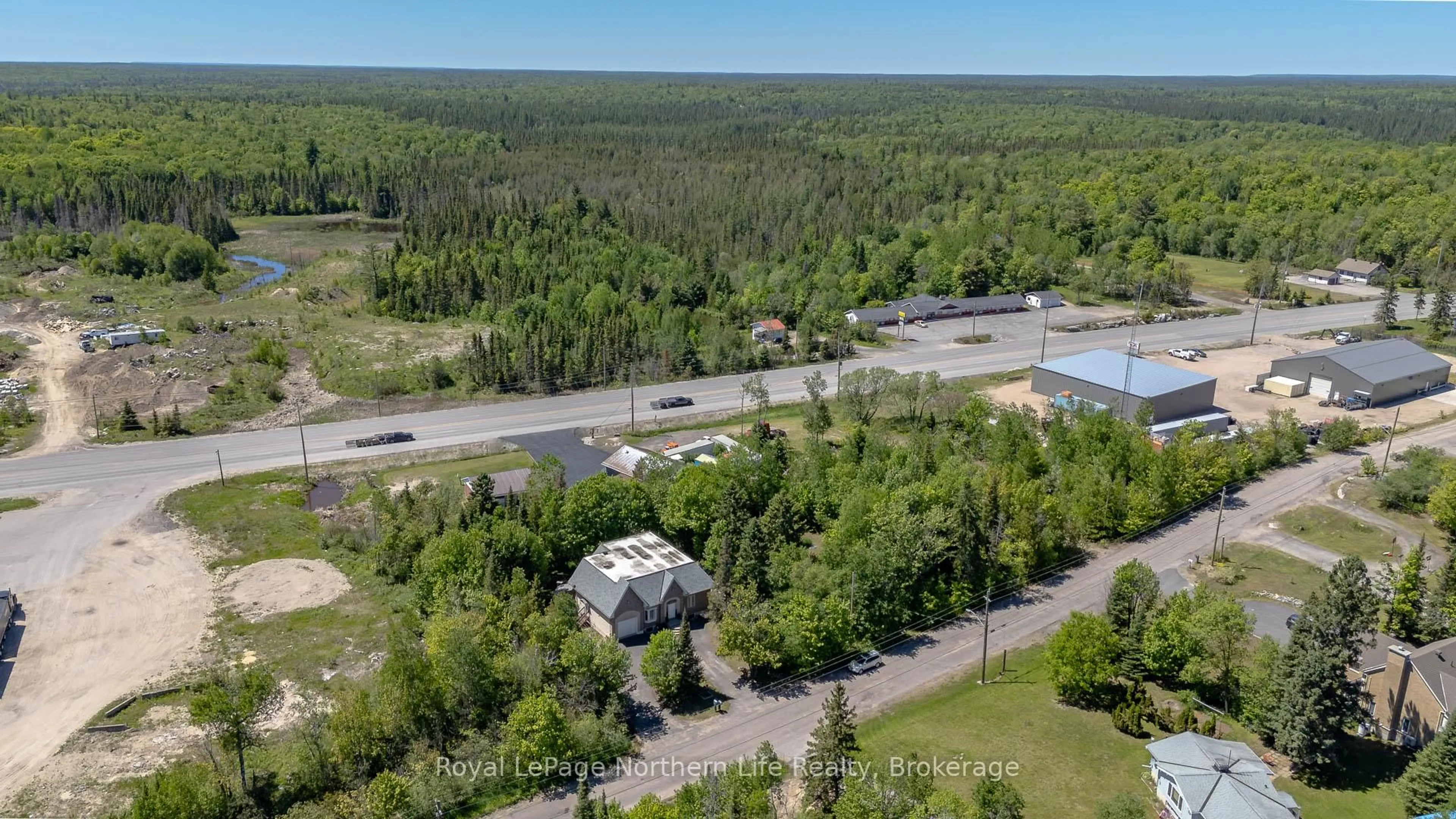 A pic from outside/outdoor area/front of a property/back of a property/a pic from drone, forest/trees view for 421 Collins Dr, North Bay Ontario P1B 8G3