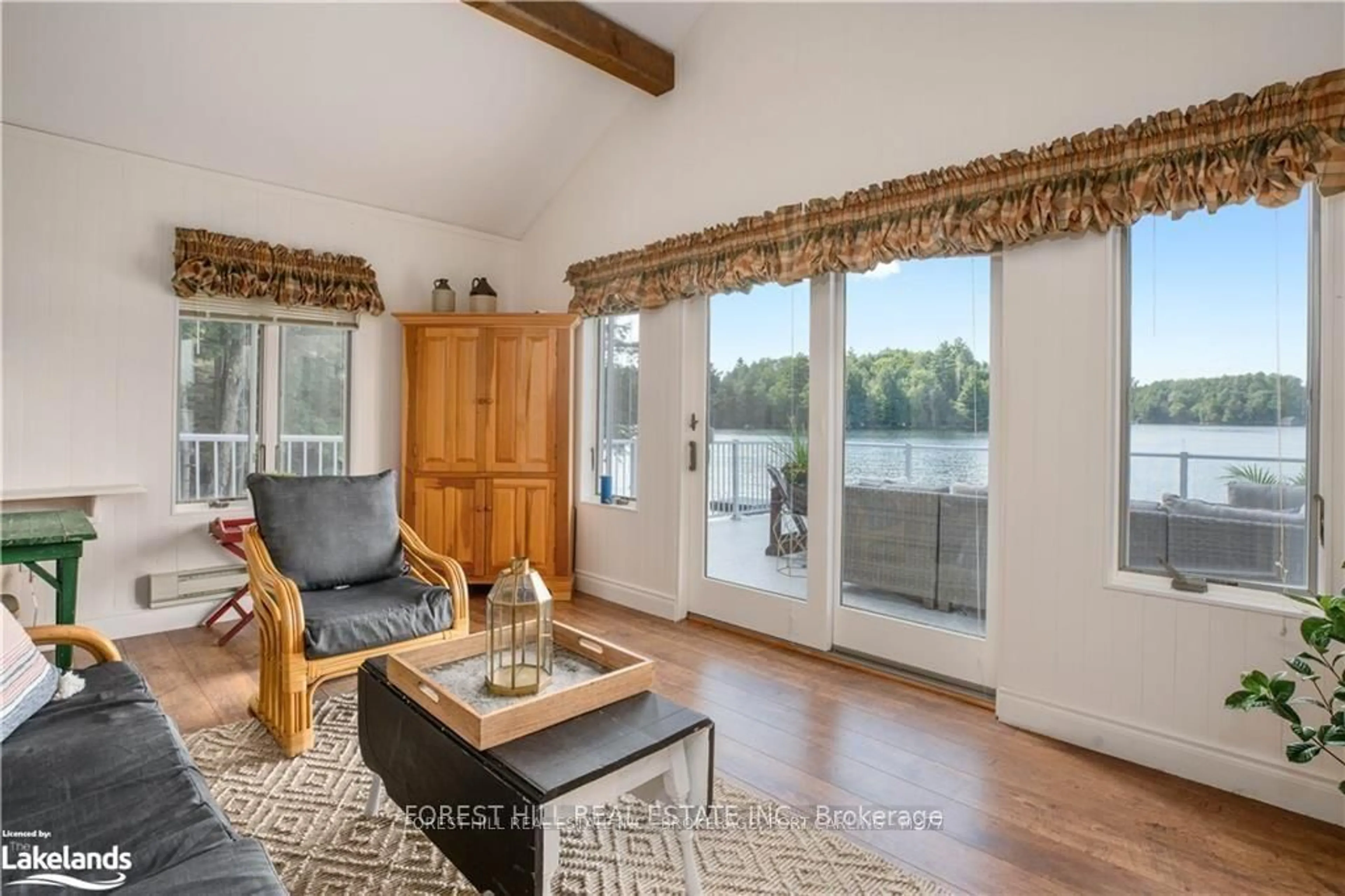 Living room with furniture, wood/laminate floor for 1004 Old Township Rd, Muskoka Lakes Ontario P0B 1J0