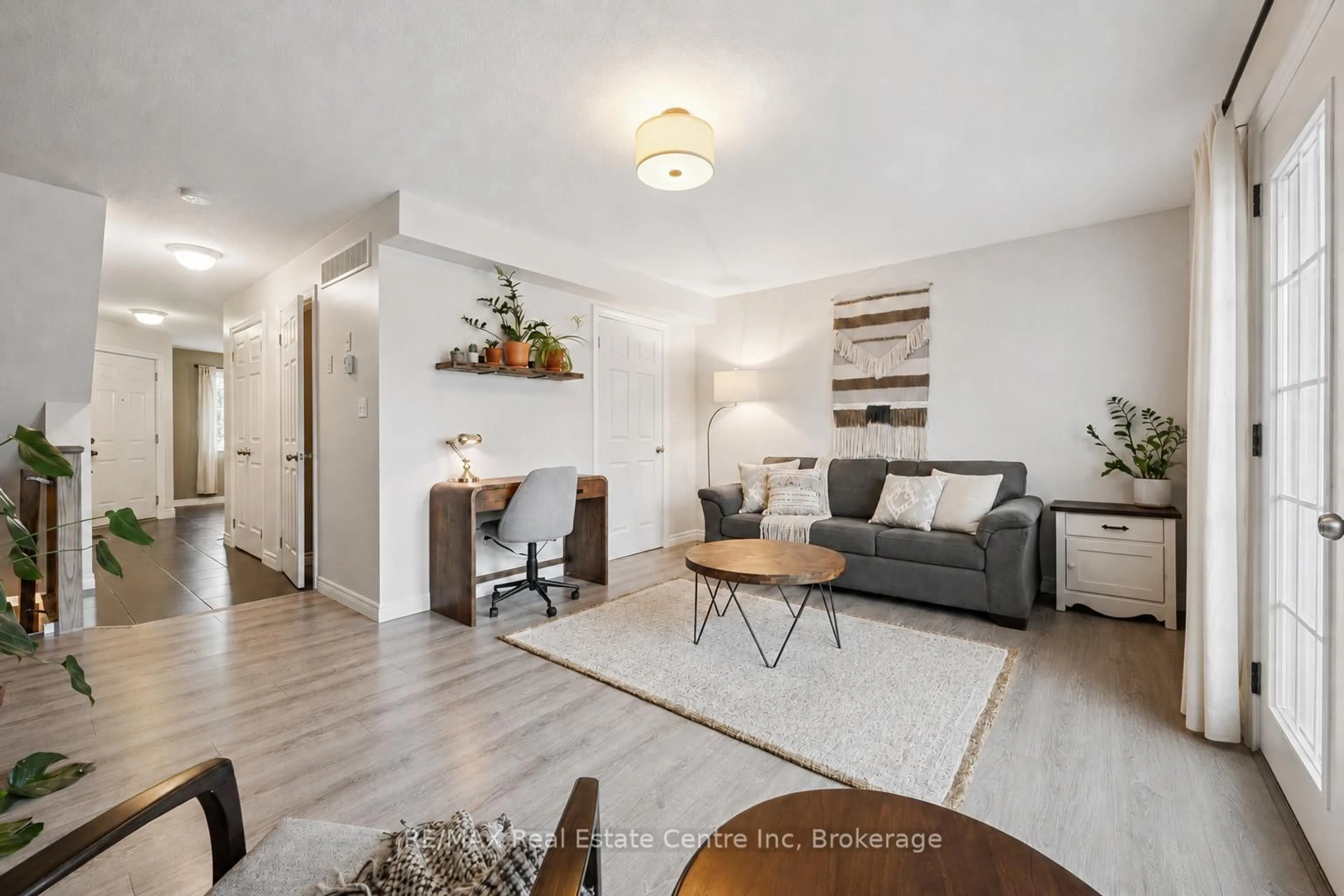 Living room with furniture, wood/laminate floor for 634 WOODLAWN Rd #A, Guelph Ontario N1E 0K4