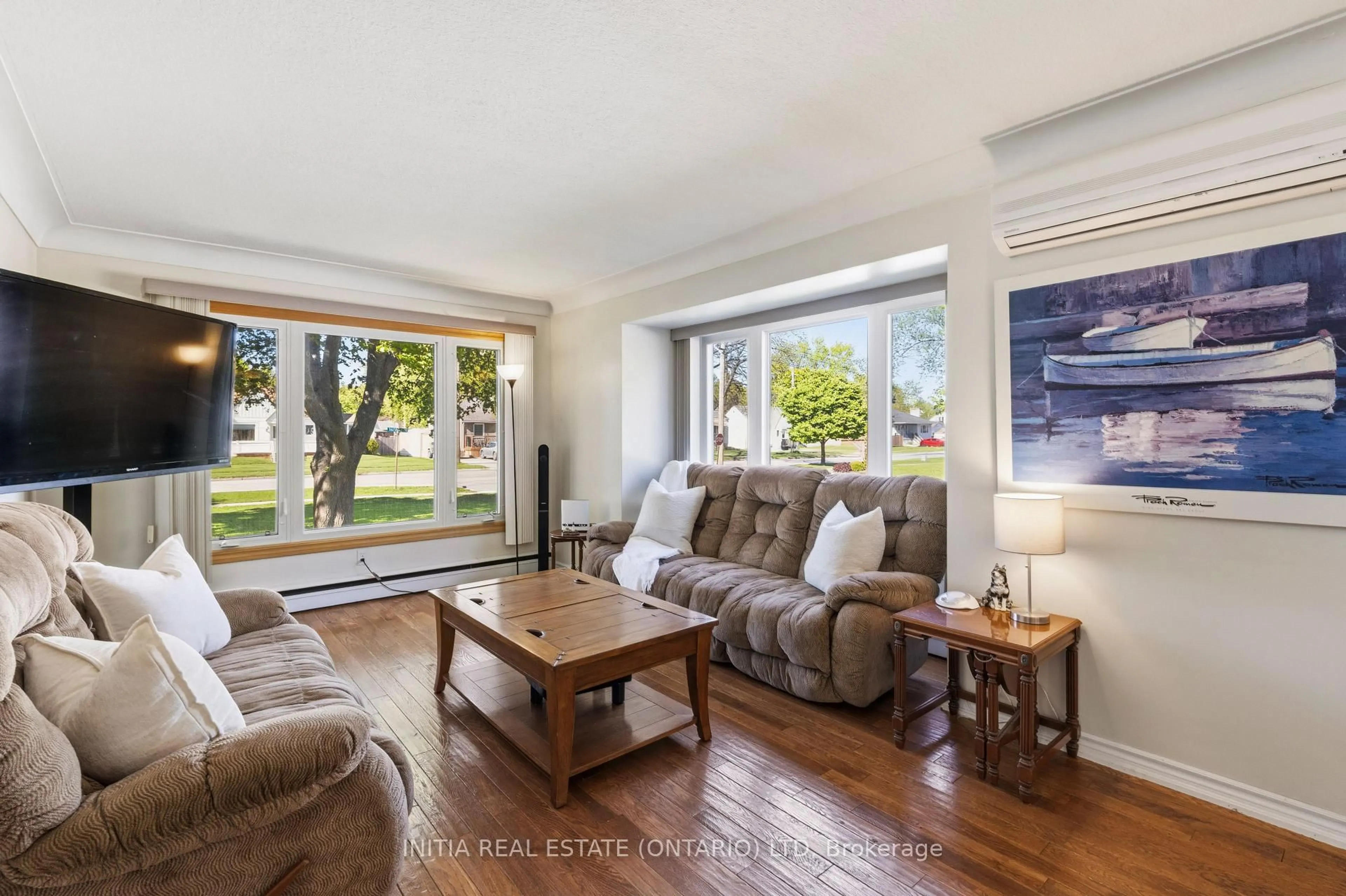 Living room with furniture, wood/laminate floor for 755 Talfourd St, Sarnia Ontario N7T 1S1