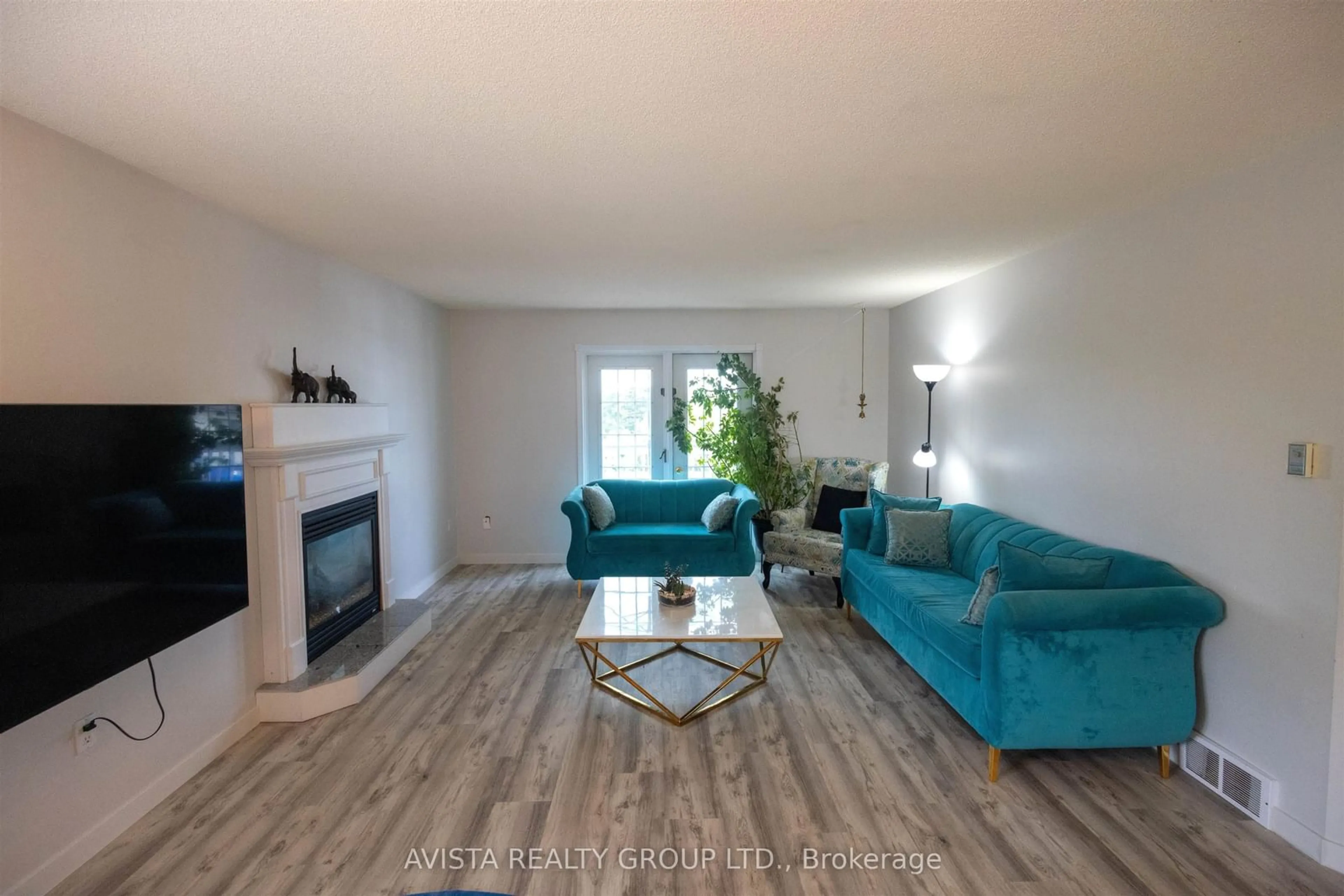 Living room with furniture, wood/laminate floor for 401 Tuscany Dr, Thunder Bay Ontario P7G 1B7