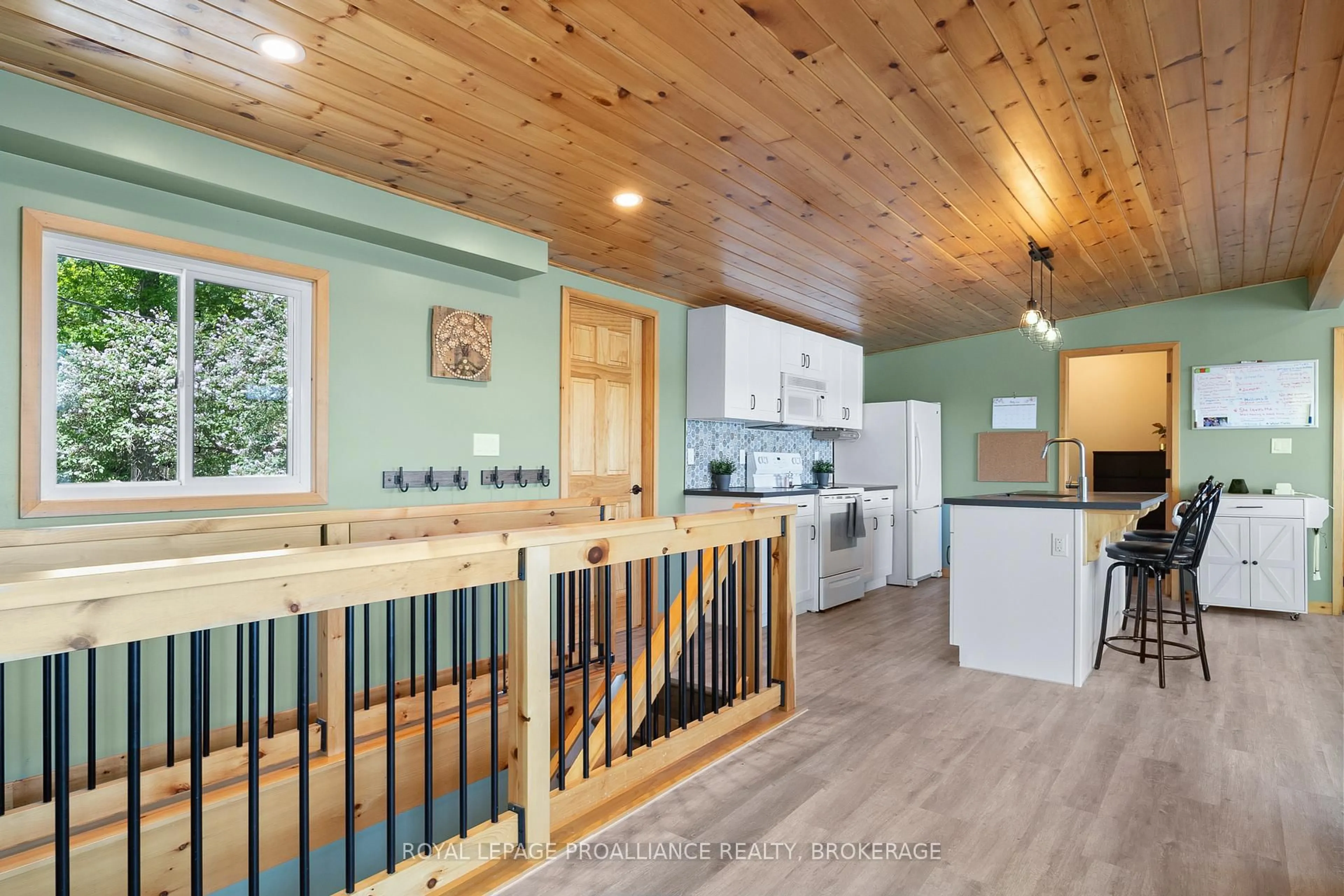 Open concept kitchen, wood/laminate floor for 402 Troy Lake Rd, Rideau Lakes Ontario K0G 1E0
