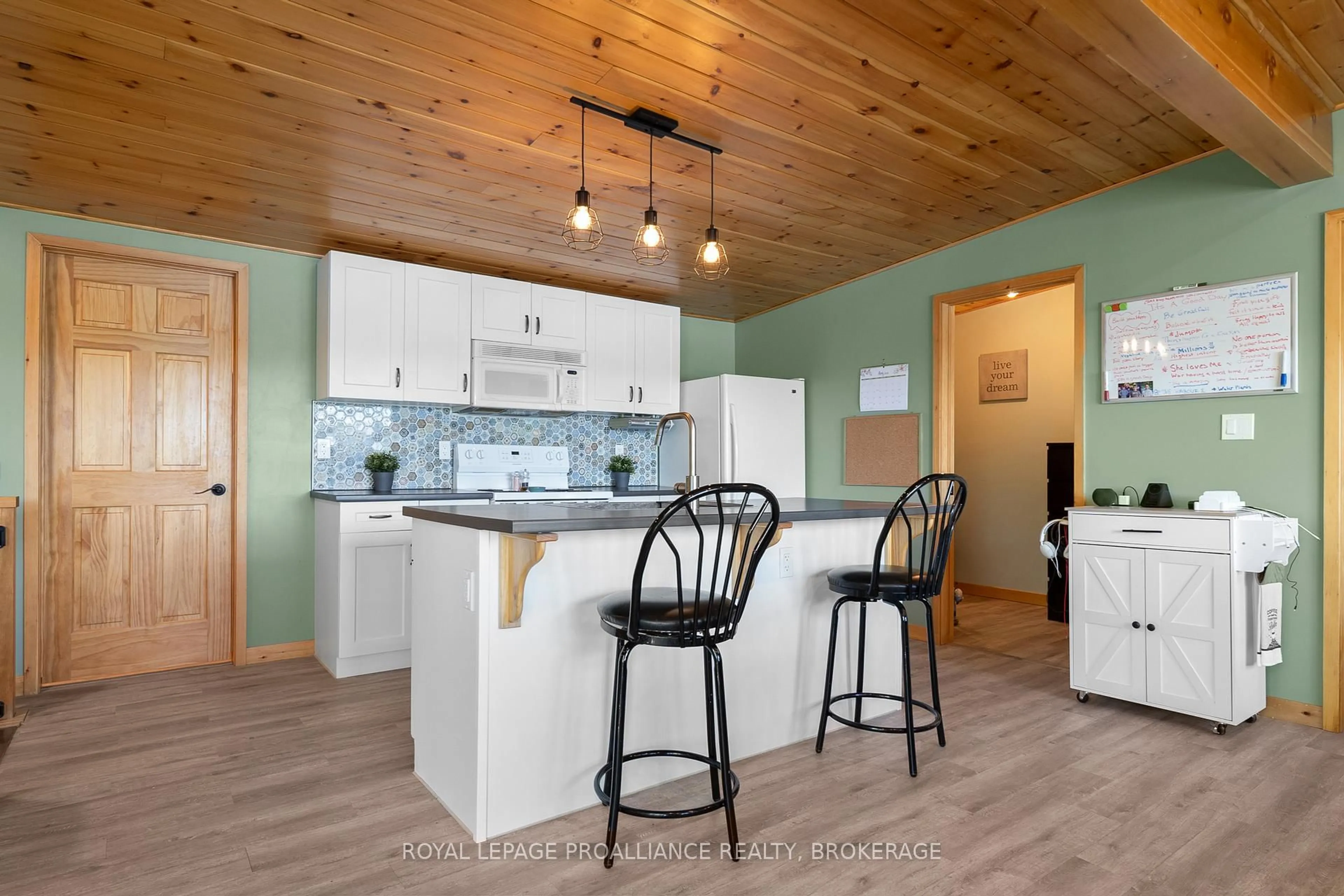 Open concept kitchen, wood/laminate floor for 402 Troy Lake Rd, Rideau Lakes Ontario K0G 1E0