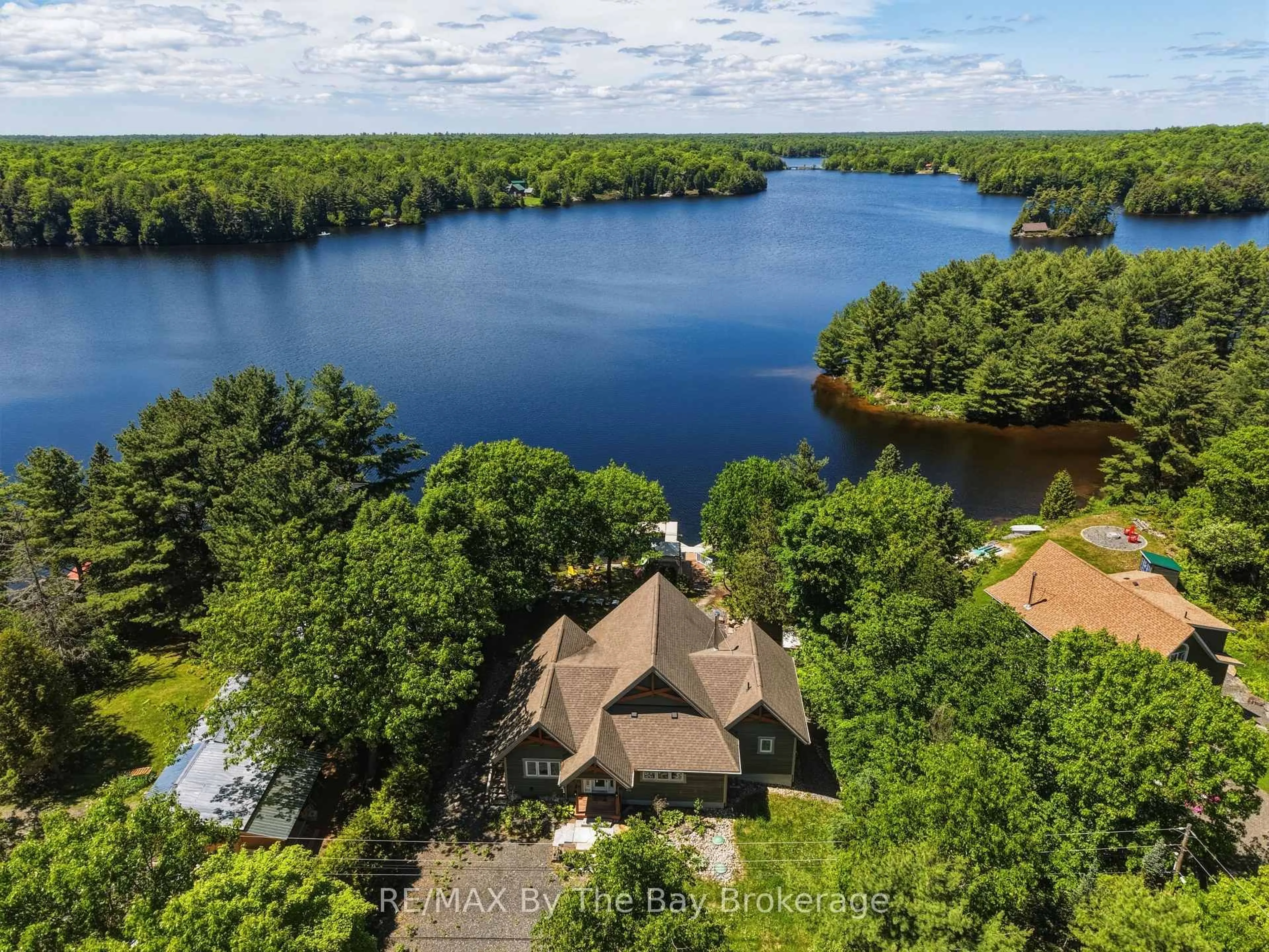A pic from outside/outdoor area/front of a property/back of a property/a pic from drone, water/lake/river/ocean view for 61 Mckellar Lake Rd, McKellar Ontario P0G 1C0