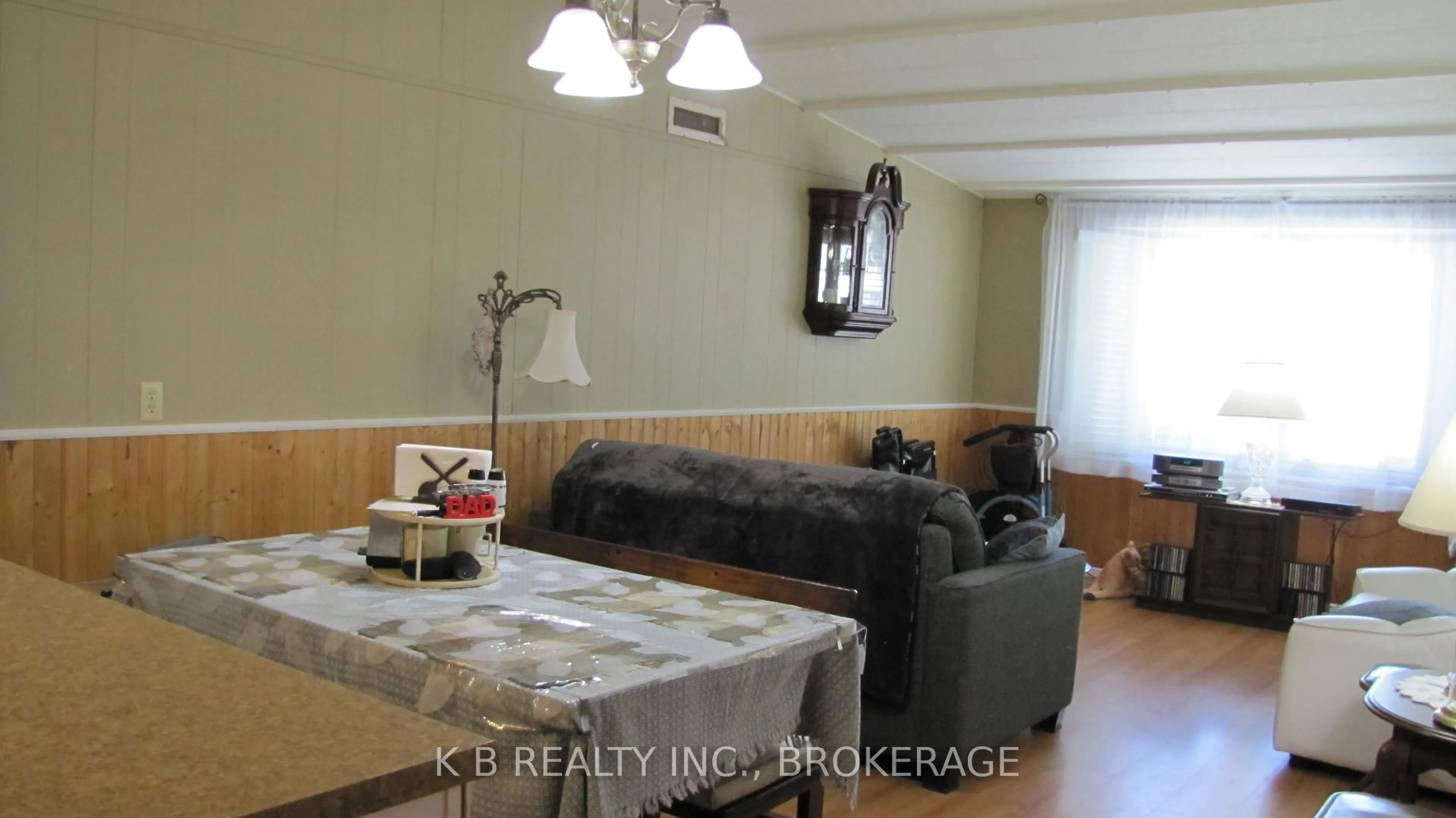 Living room with furniture, wood/laminate floor for 53 Worthington Way, Kingston Ontario K7K 5C2