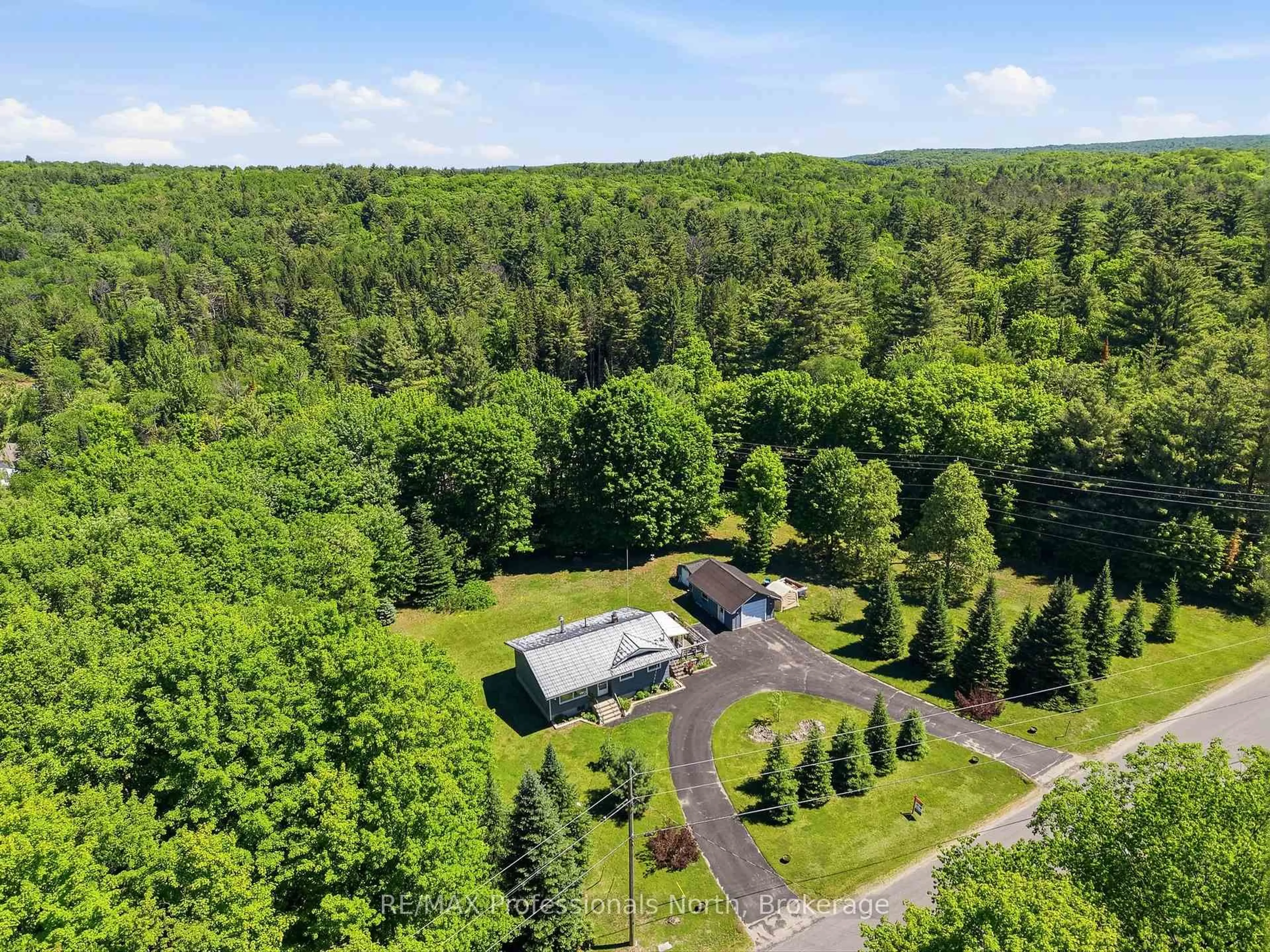 A pic from outside/outdoor area/front of a property/back of a property/a pic from drone, forest/trees view for 329 Waseosa Lake Rd, Huntsville Ontario P1H 2J4