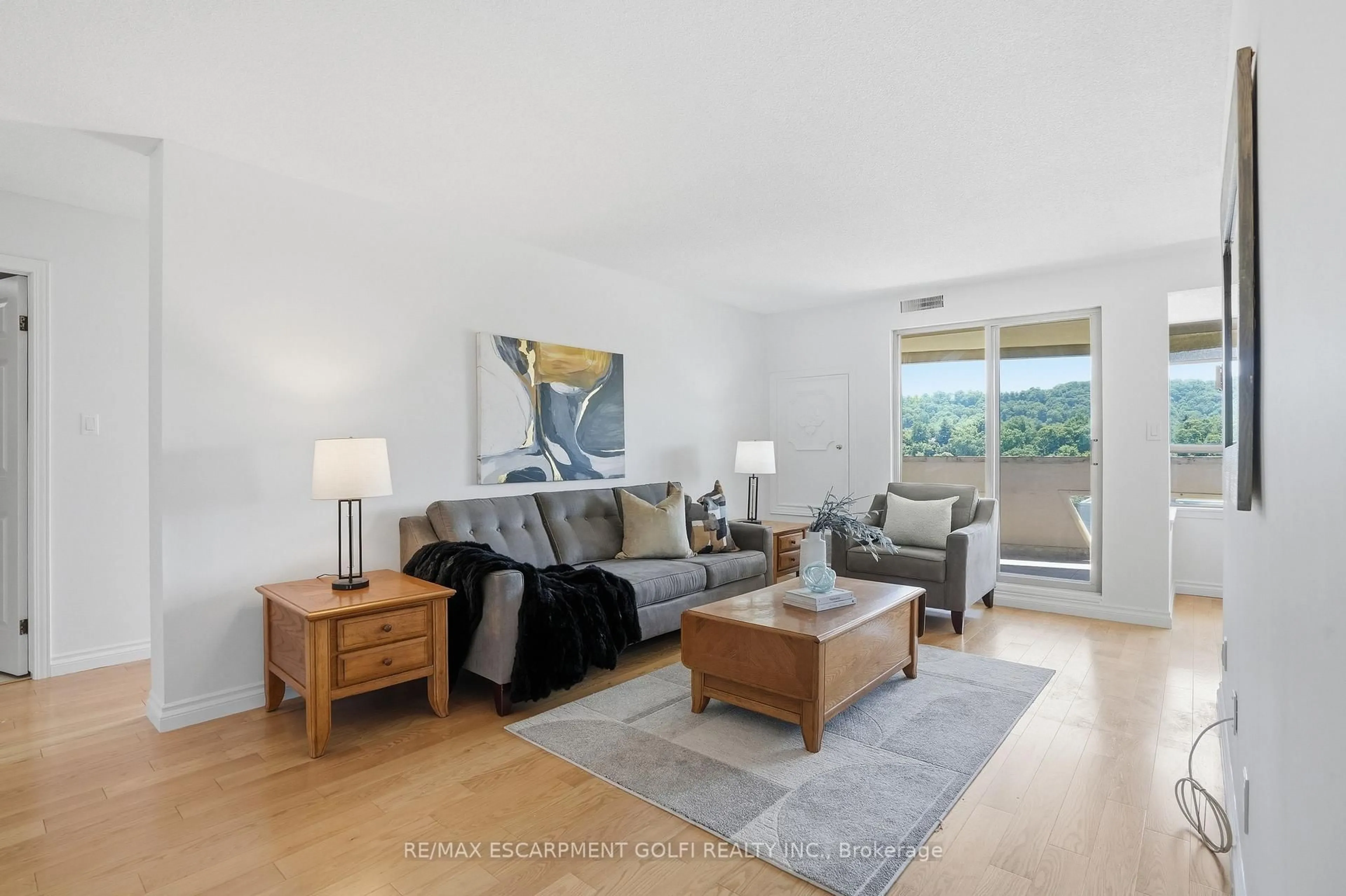 Living room with furniture, wood/laminate floor for 8 Village Green Blvd #812, Hamilton Ontario L8G 5B8
