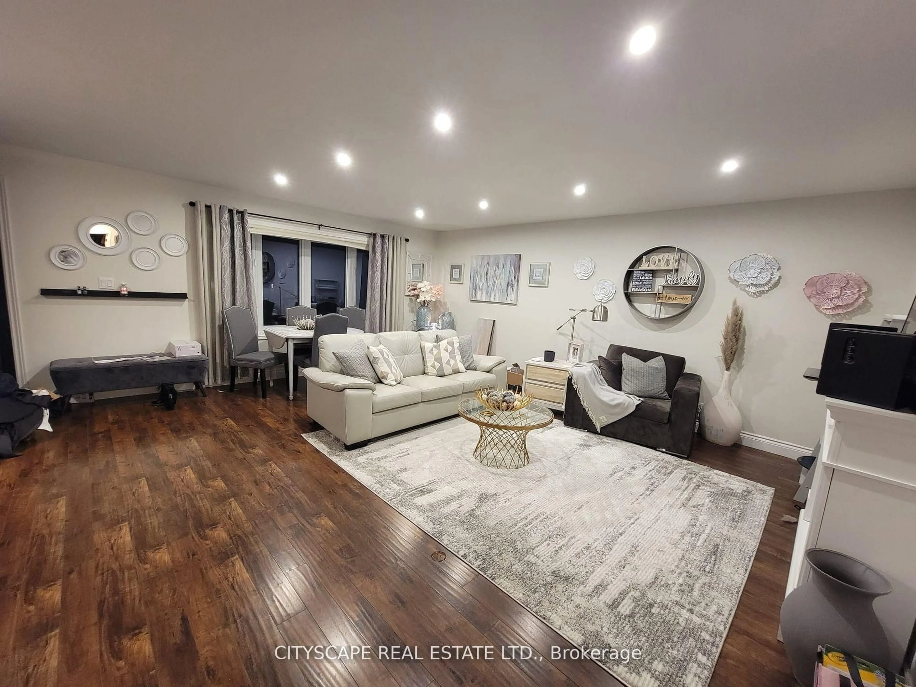 Living room with furniture, wood/laminate floor for 891 Curtis Cres, Cobourg Ontario K9A 2W2
