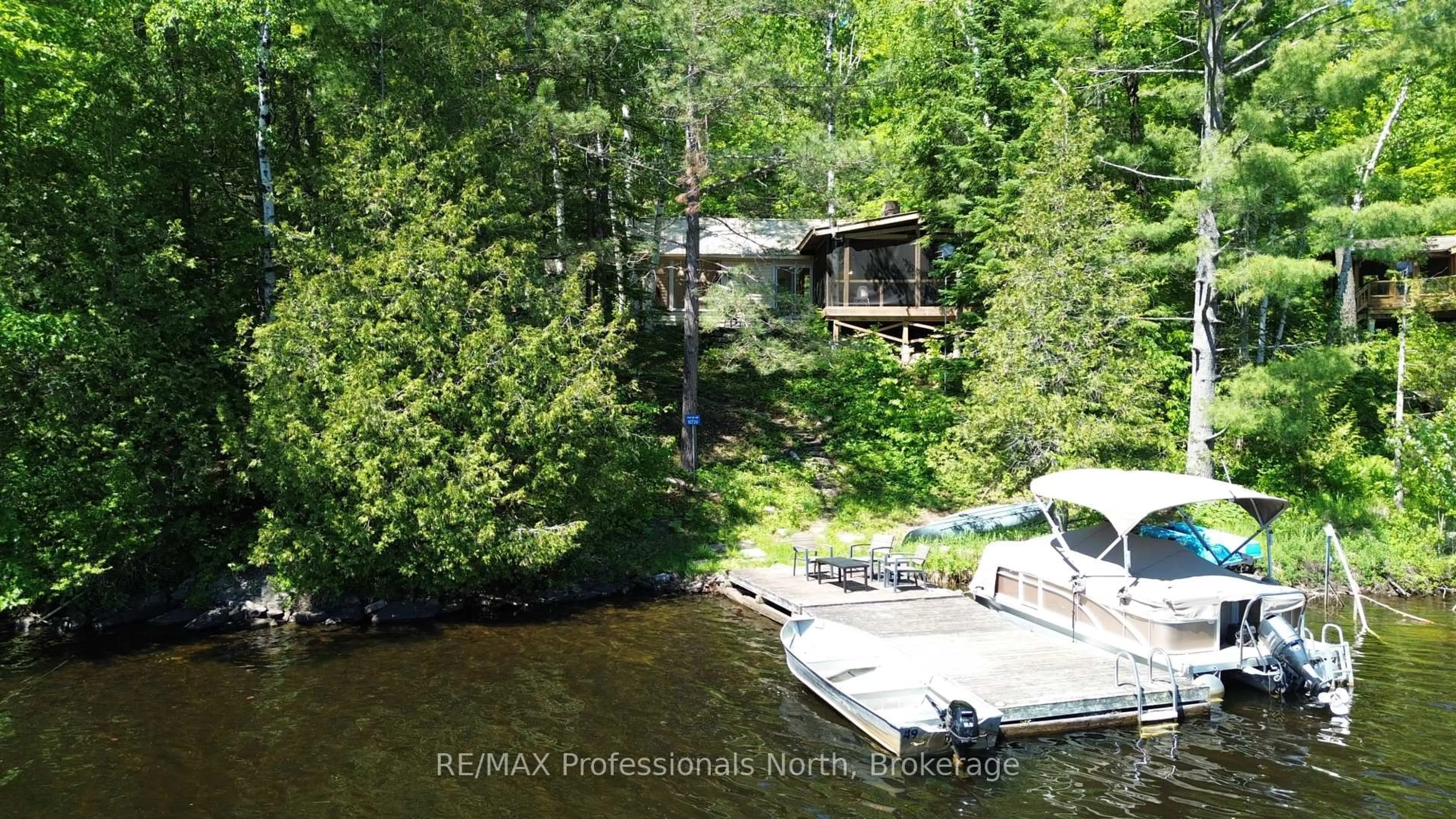 A pic from outside/outdoor area/front of a property/back of a property/a pic from drone, water/lake/river/ocean view for 10729 Black Lake WAO, Minden Hills Ontario K0M 2L1