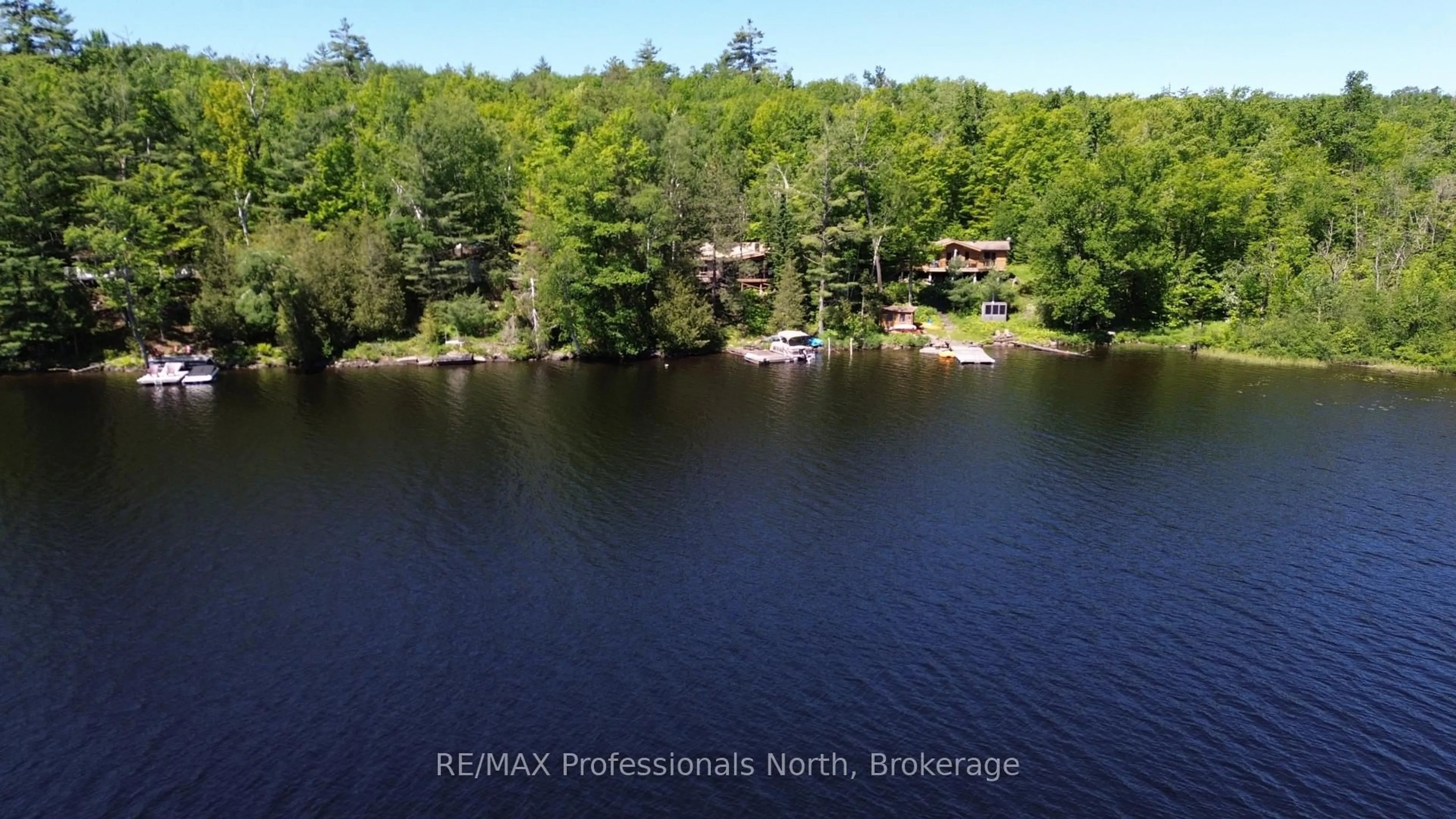 A pic from outside/outdoor area/front of a property/back of a property/a pic from drone, water/lake/river/ocean view for 10729 Black Lake WAO, Minden Hills Ontario K0M 2L1
