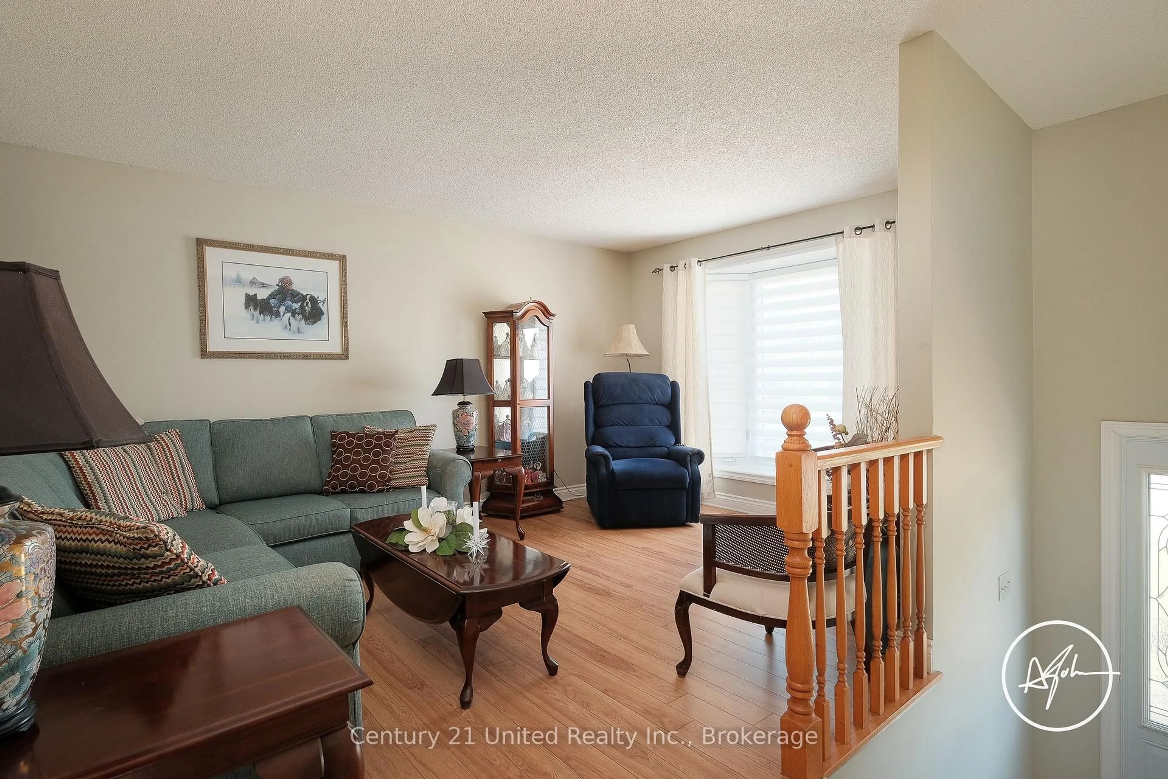 Living room with furniture, wood/laminate floor for 2606 Foxmeadow Rd, Peterborough Ontario K9L 1X3