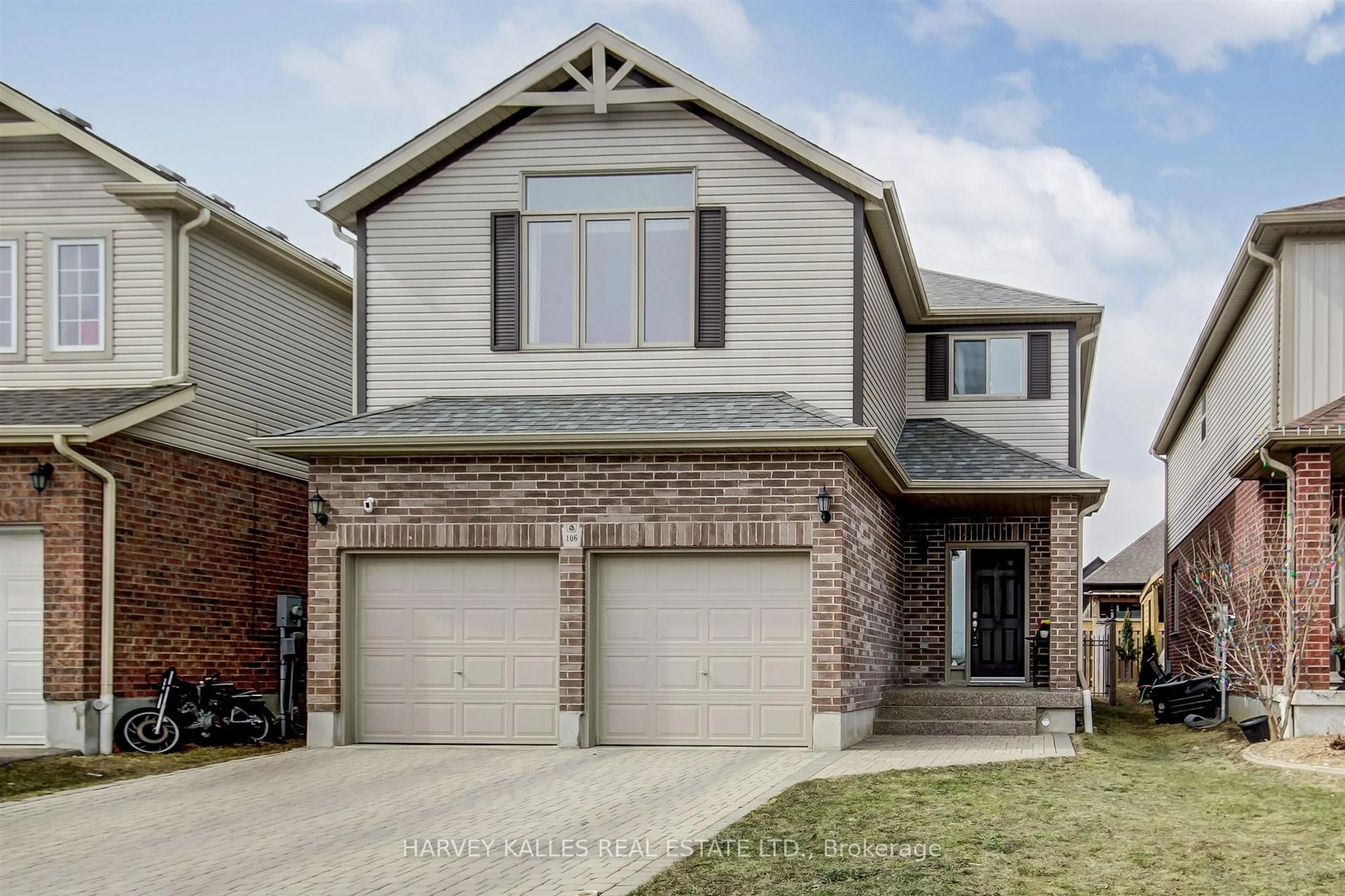 Home with brick exterior material, street for 106 Eden Oak Tr, Kitchener Ontario N2A 0G1