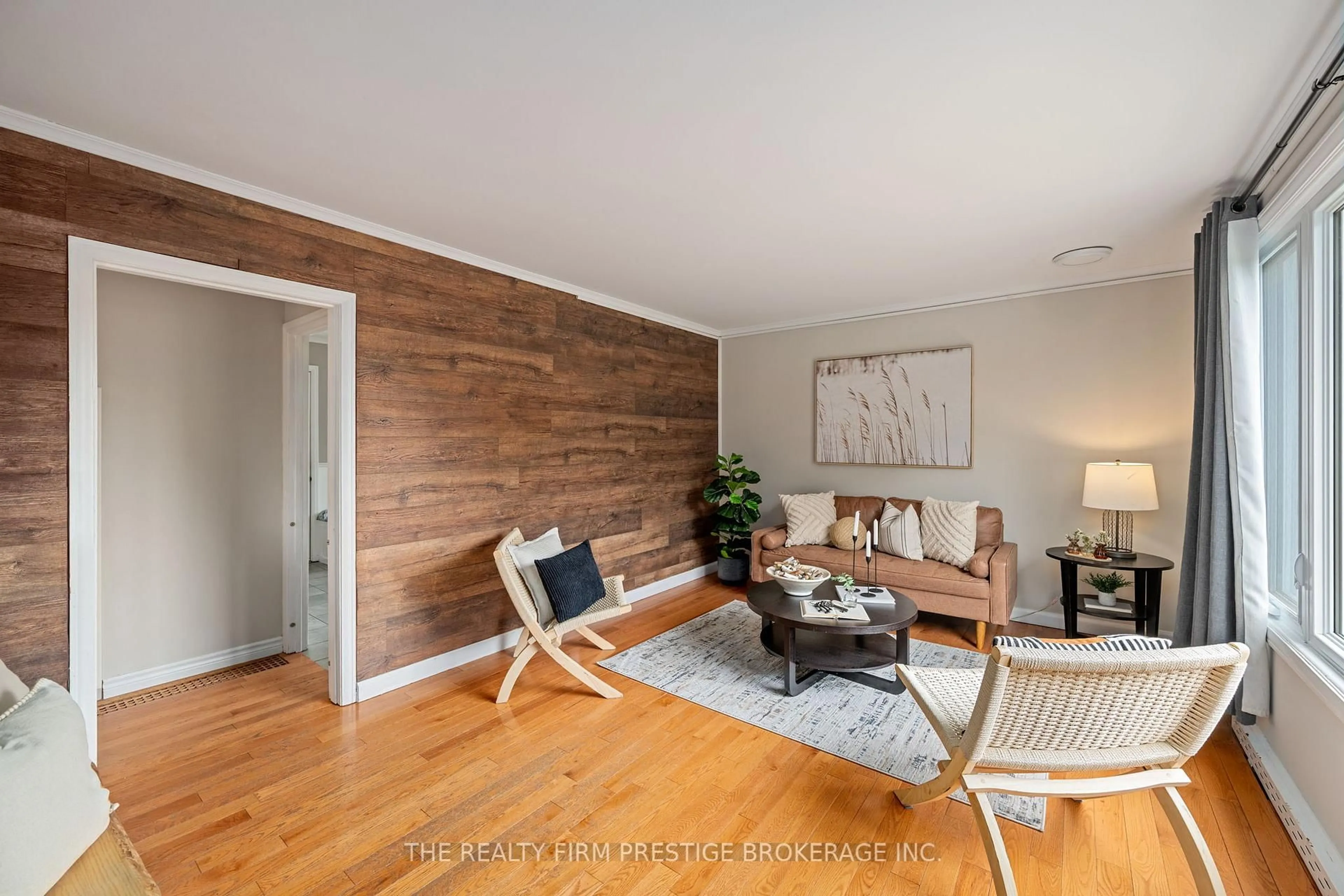 Living room with furniture, wood/laminate floor for 6806 James St, London South Ontario N6P 1A4