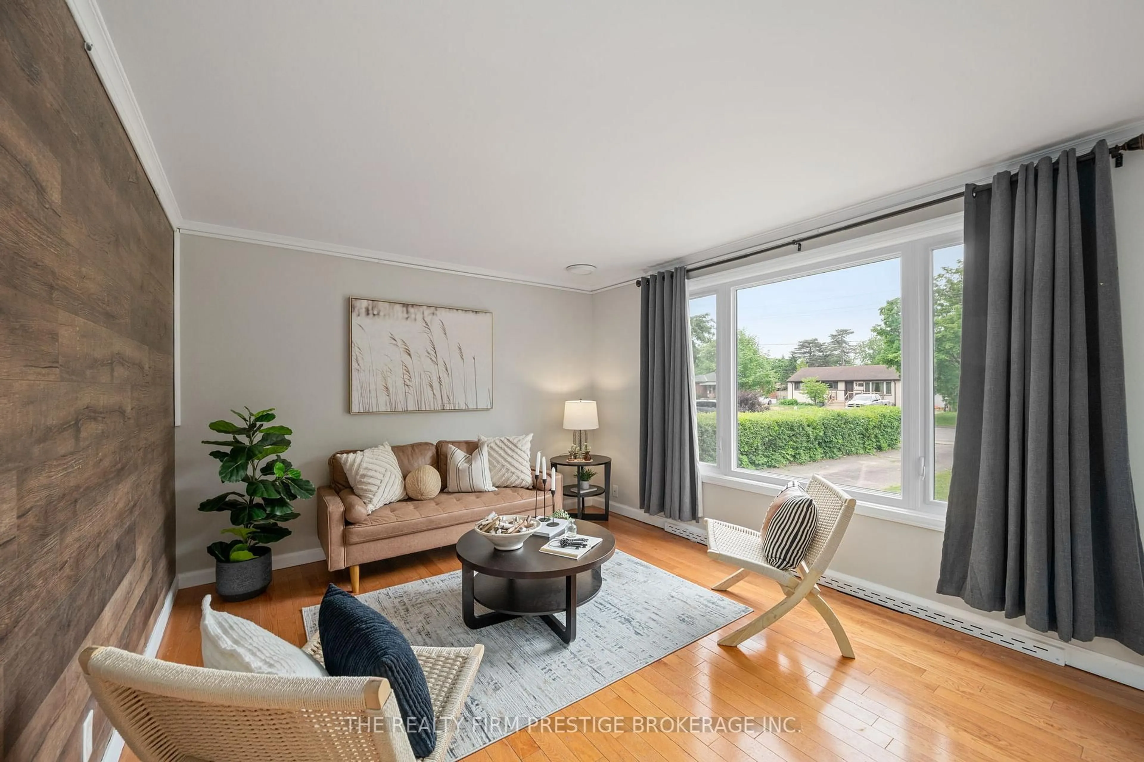 Living room with furniture, wood/laminate floor for 6806 James St, London South Ontario N6P 1A4