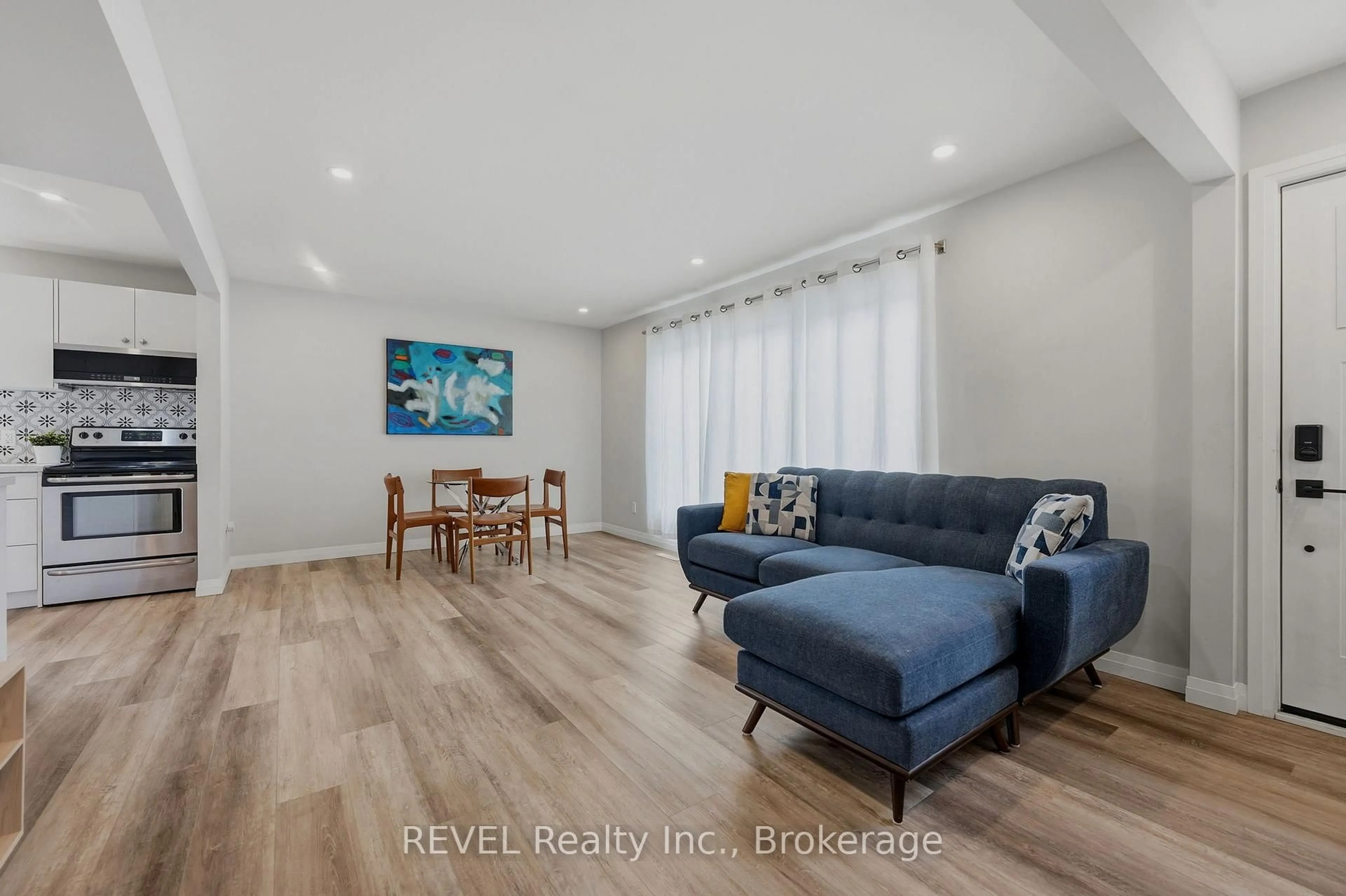 Living room with furniture, wood/laminate floor for 7859 Mulhern St, Niagara Falls Ontario L2H 1B6