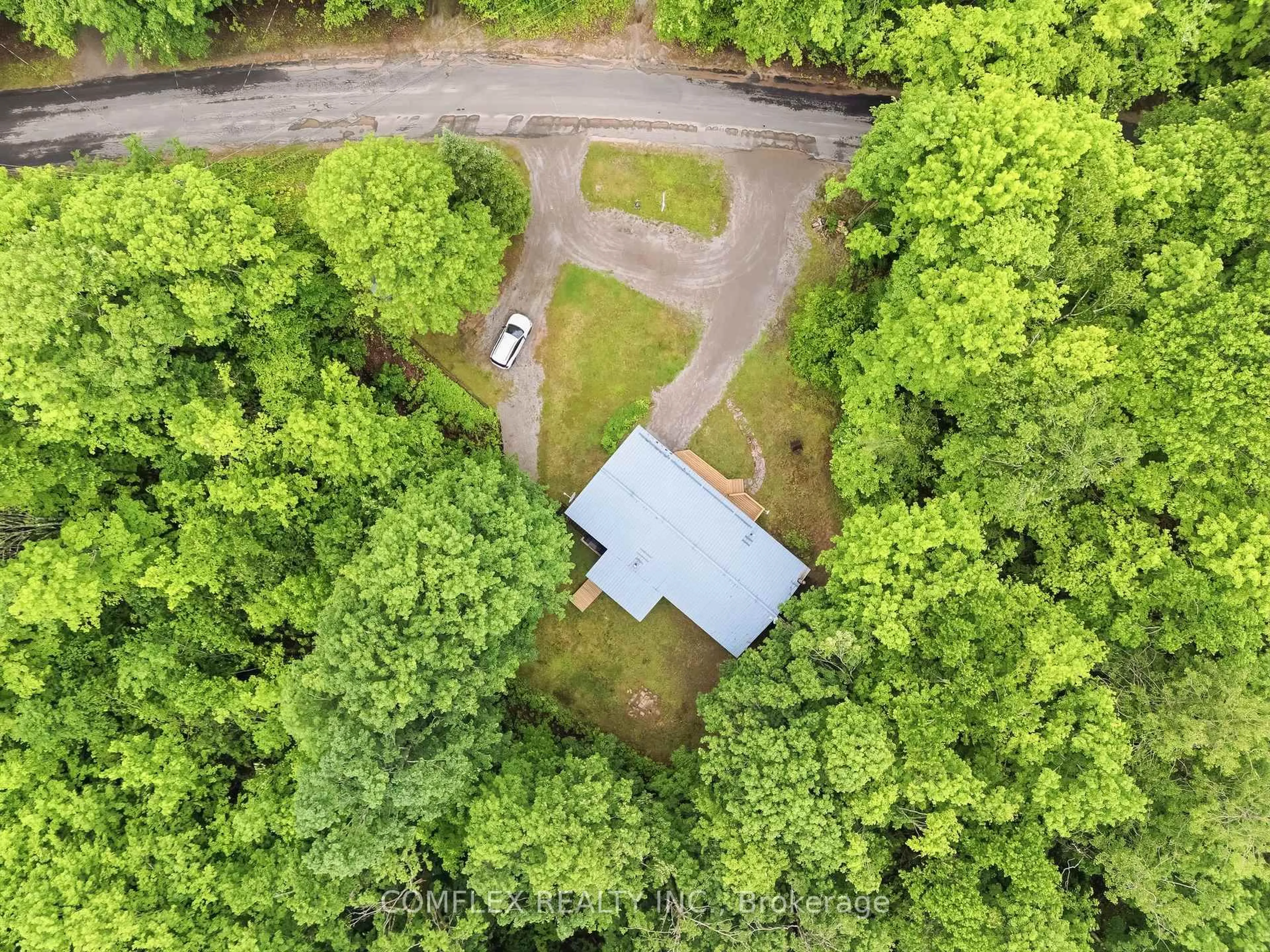 A pic from outside/outdoor area/front of a property/back of a property/a pic from drone, forest/trees view for 1354 Clear Lake Rd, Minden Hills Ontario K0M 2L1