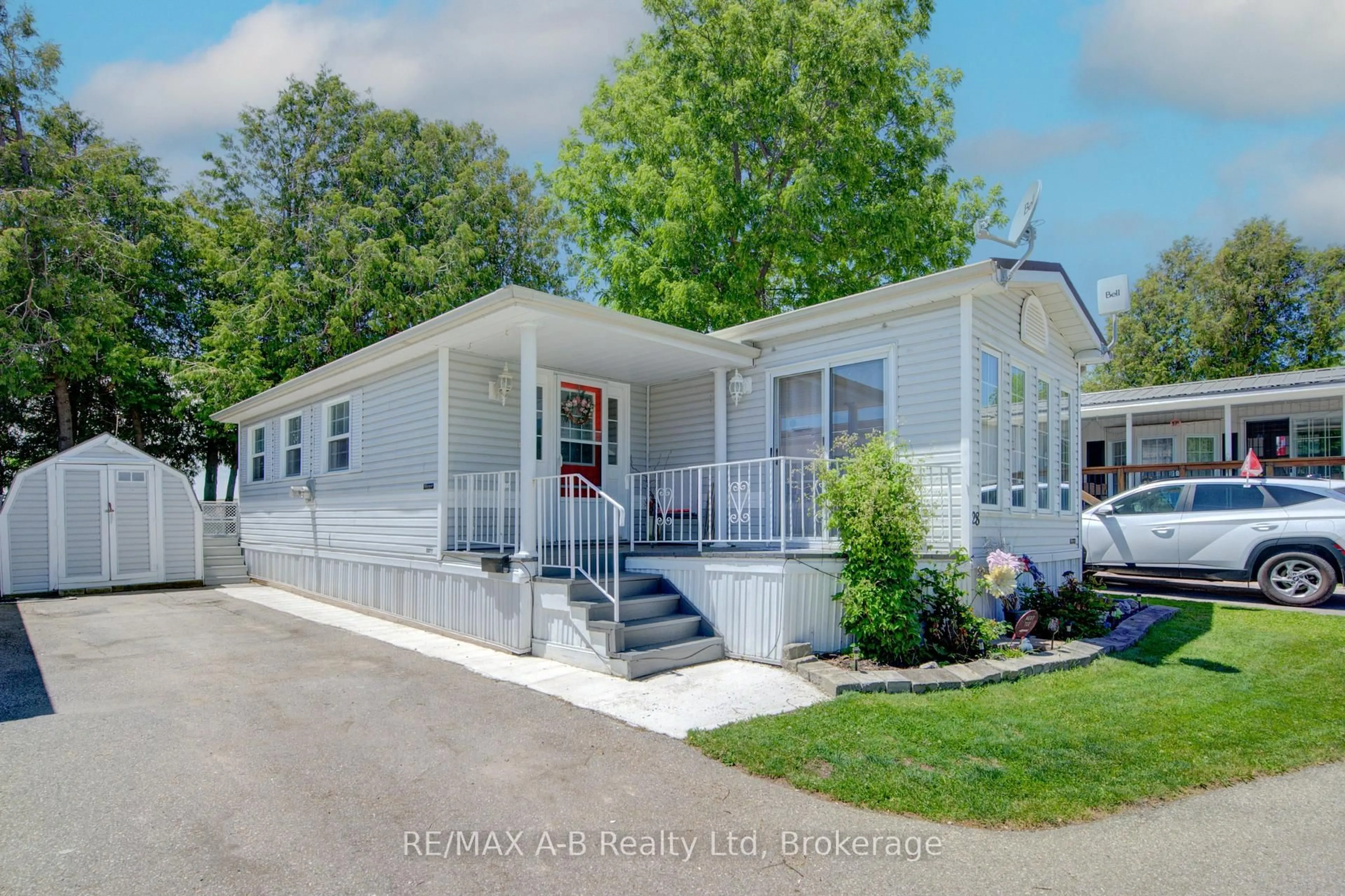 Home with vinyl exterior material, street for 595487 Highway 59 North, Rr6 Woodstock - Unit Highway #28, East Zorra-Tavistock Ontario N4S 7W1