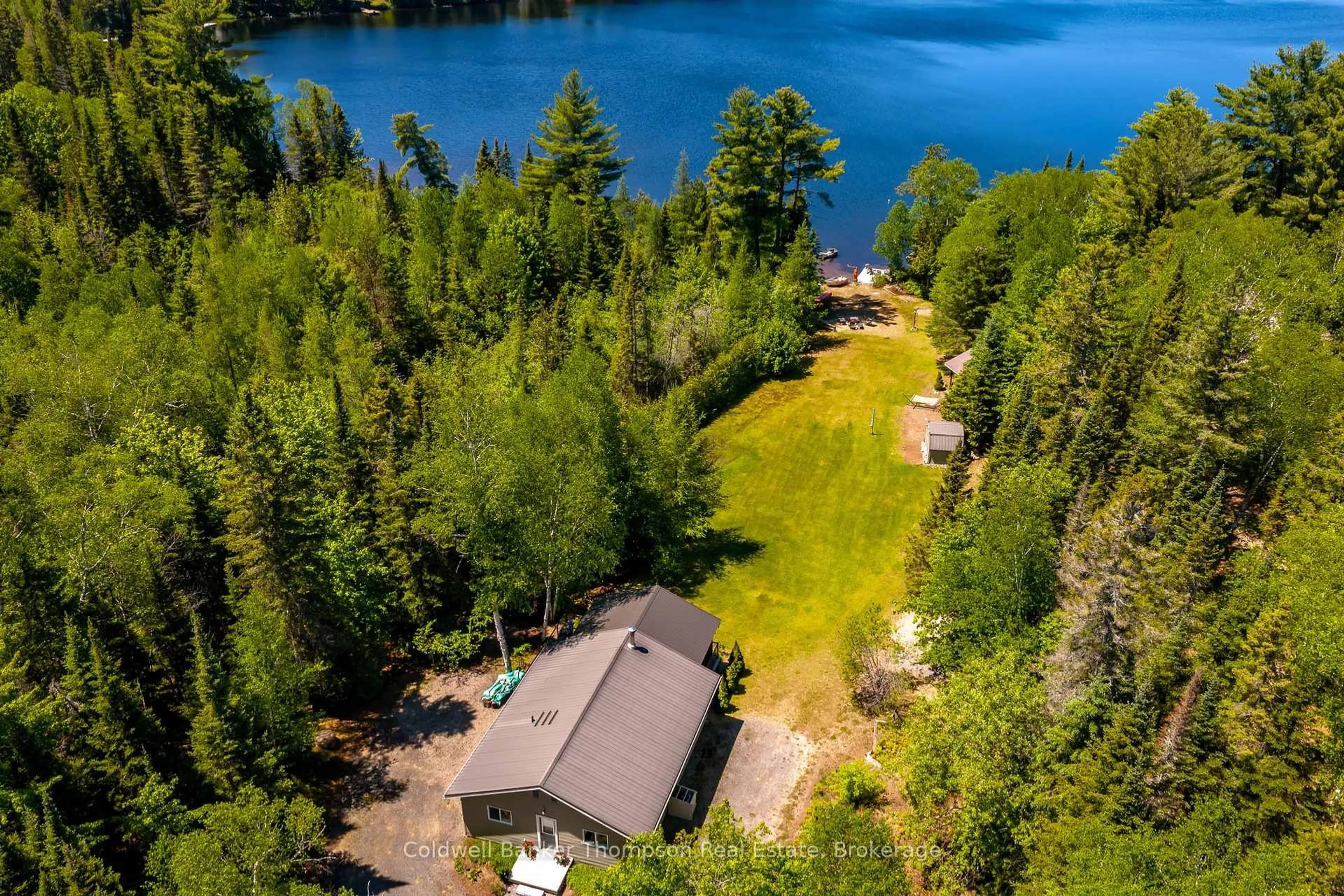 A pic from outside/outdoor area/front of a property/back of a property/a pic from drone, water/lake/river/ocean view for 612 Clam Lake Rd, Kearney Ontario P0A 1M0