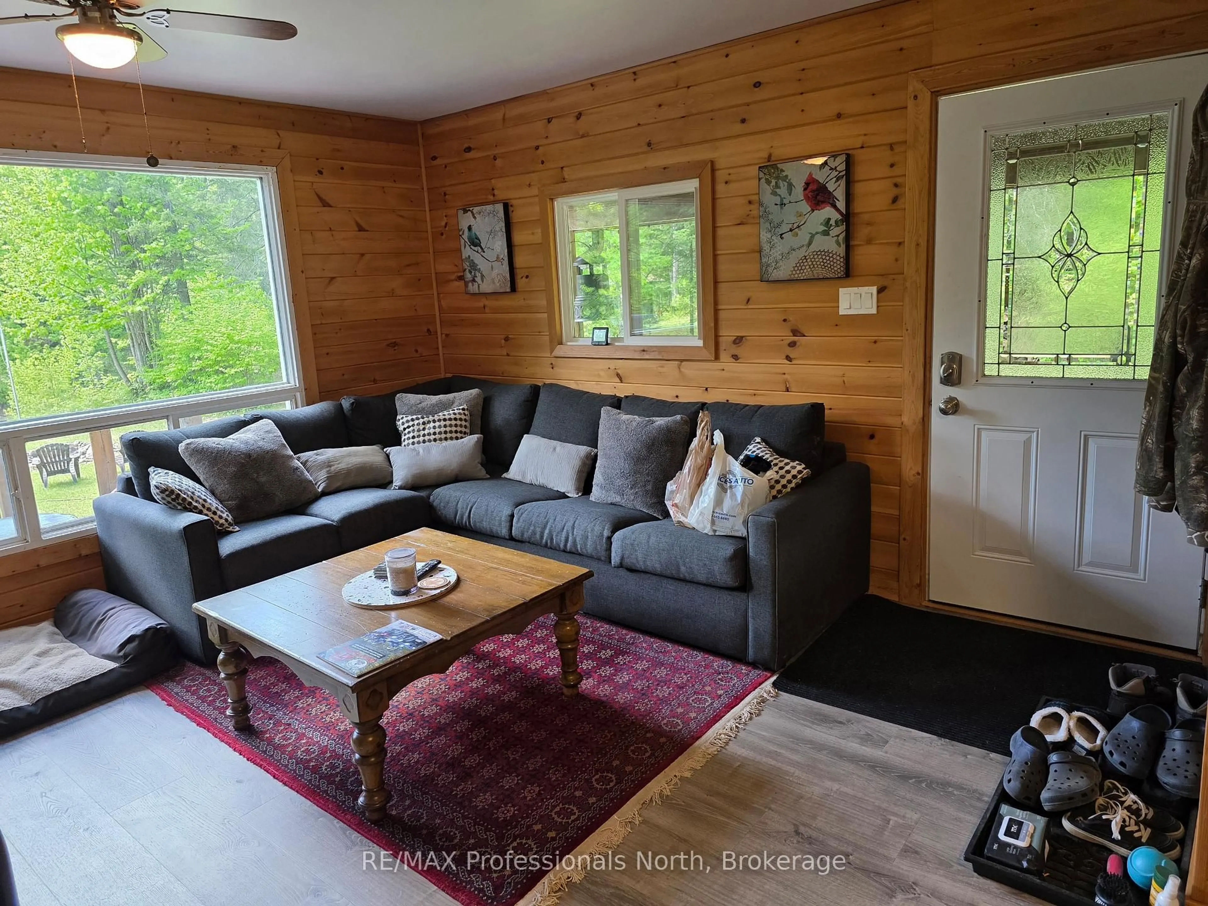 Living room with furniture, wood/laminate floor for 38 ROBERT Rd, Huntsville Ontario P1H 2J4