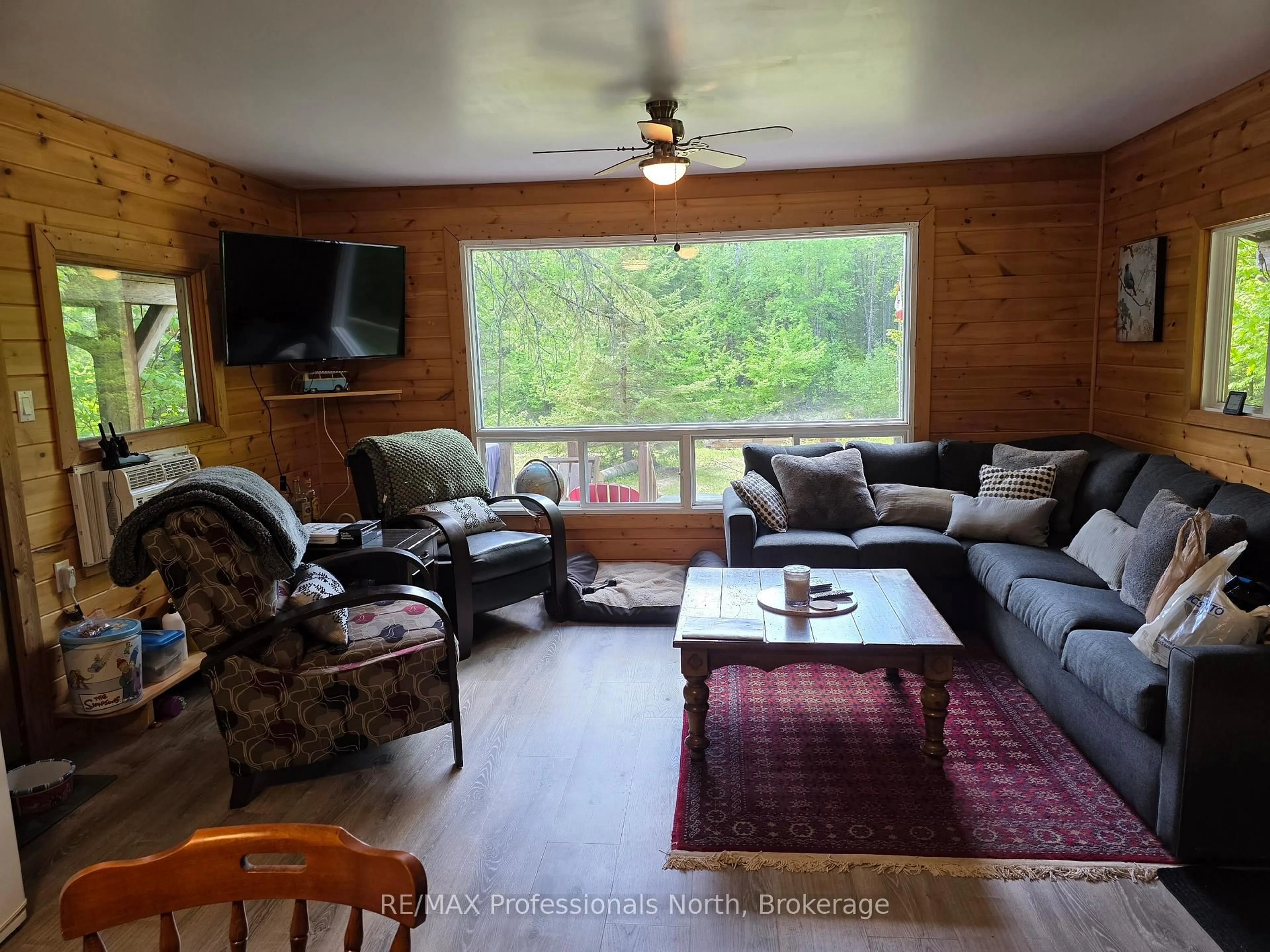 Living room with furniture, wood/laminate floor for 38 ROBERT Rd, Huntsville Ontario P1H 2J4