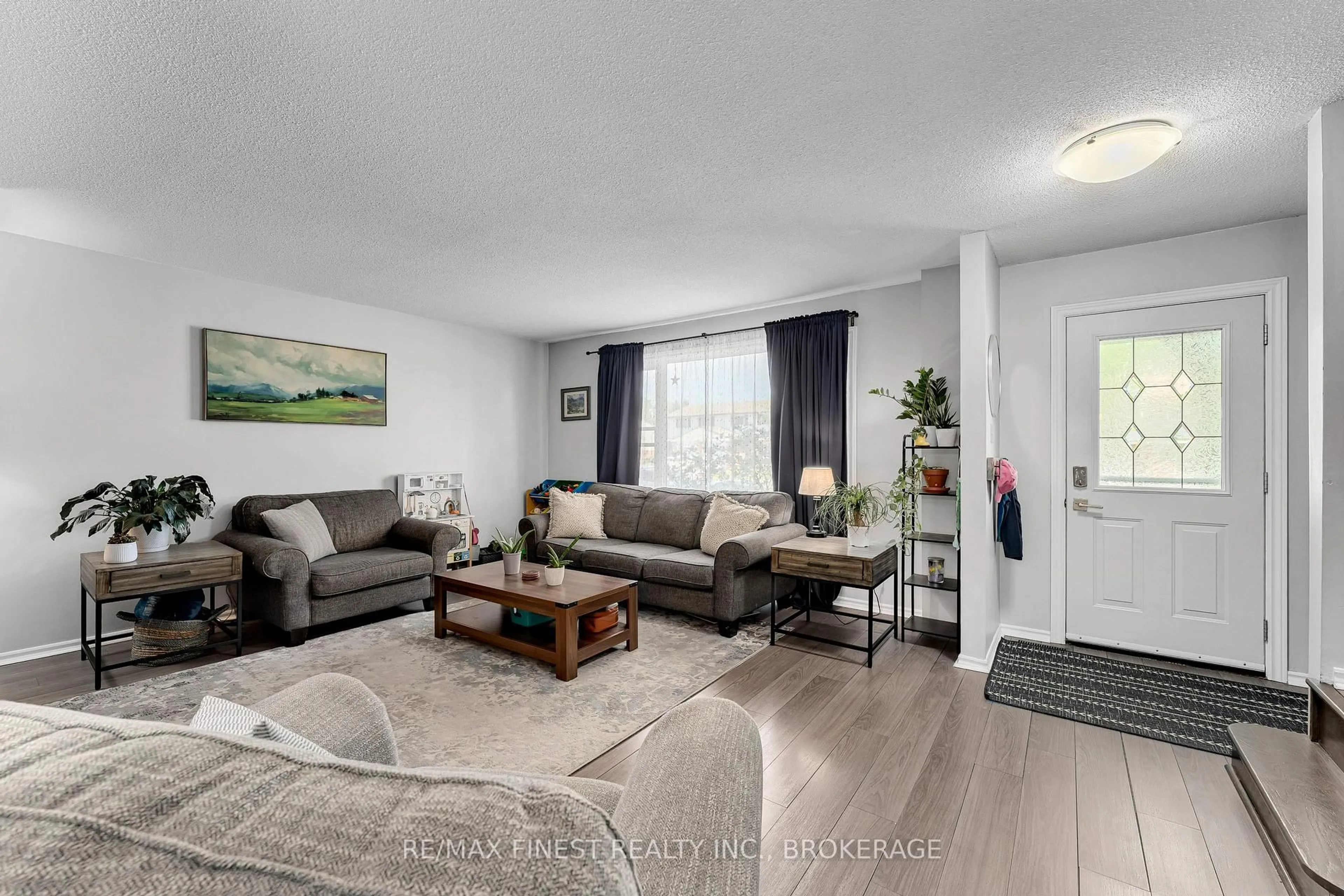 Living room with furniture, wood/laminate floor for 801 Grouse Cres, Kingston Ontario K7P 1A1